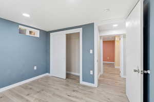Unfurnished bedroom with light wood-style flooring, a closet, and recessed lighting
