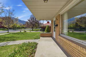 Porch with a lawn and a mountain view