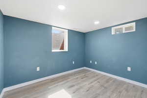 Unfurnished room with light wood finished floors and recessed lighting