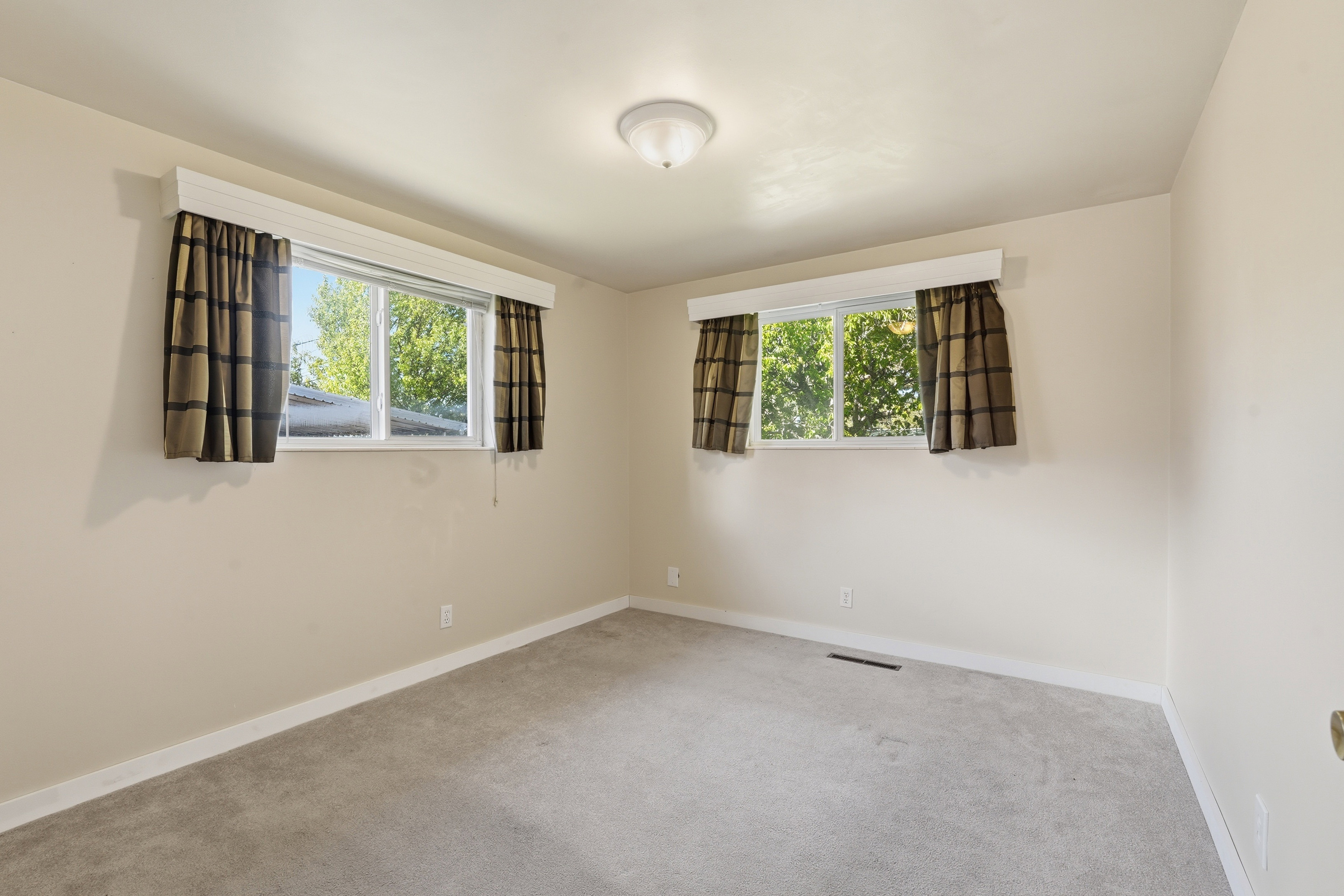 Carpeted spare room featuring plenty of natural light