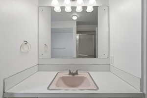 Bathroom featuring vanity and a stall shower