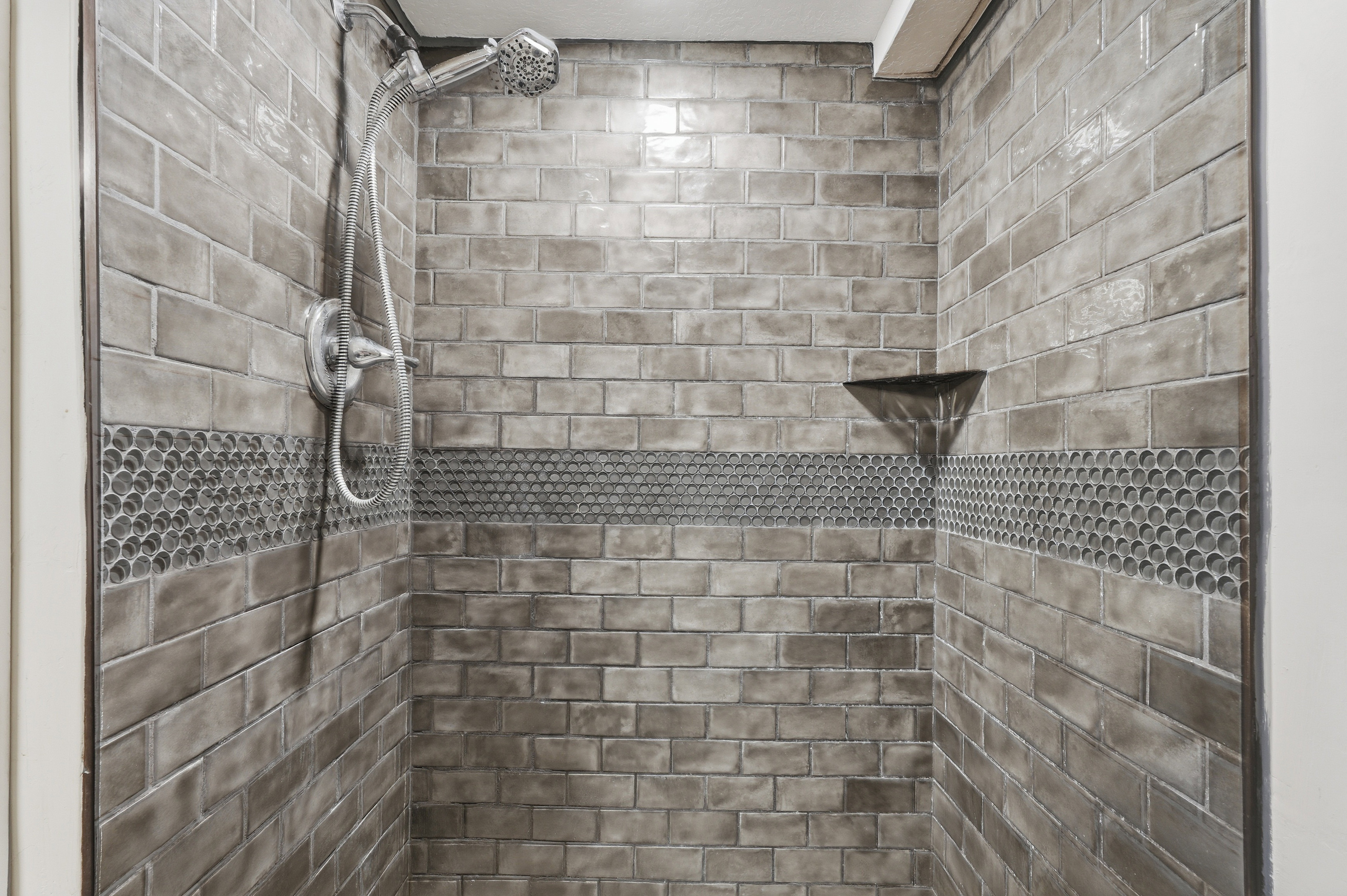 Bathroom view of a tile shower