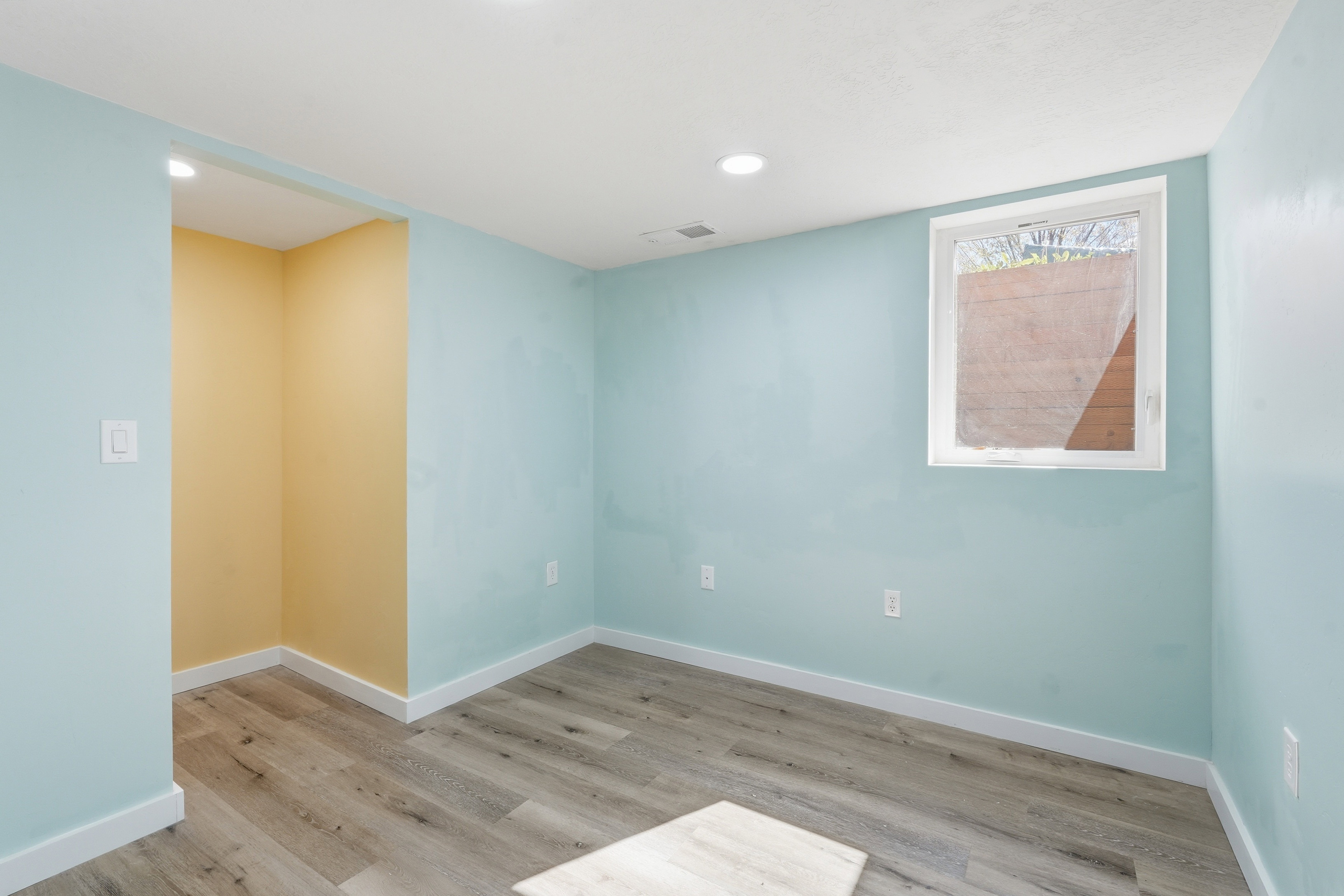 Spare room featuring light wood finished floors and recessed lighting