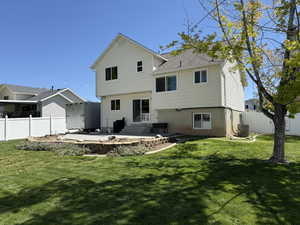 Rear view of property featuring a fenced backyard and a patio area