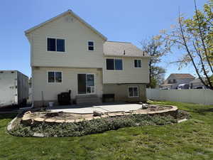 Back of house with a patio area, entry steps, and roof with shingles