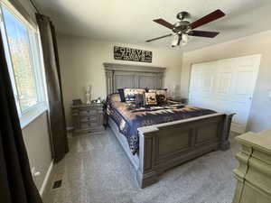 Bedroom featuring carpet flooring, a ceiling fan, a textured ceiling, and a closet