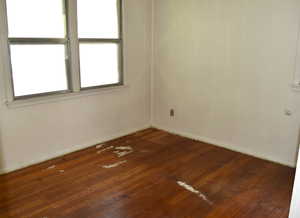 Empty room featuring dark wood finished floors