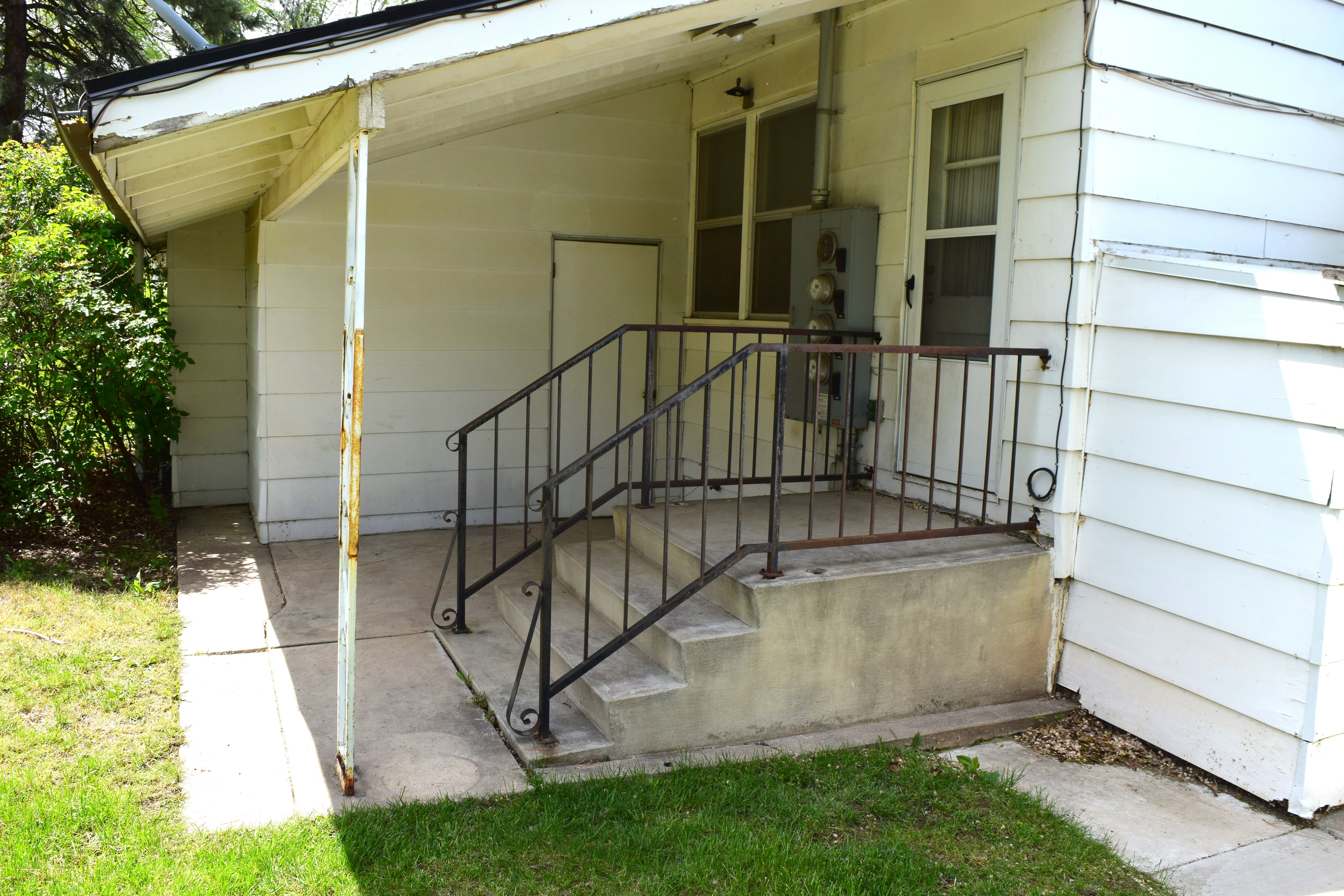 View of exterior entry featuring covered porch