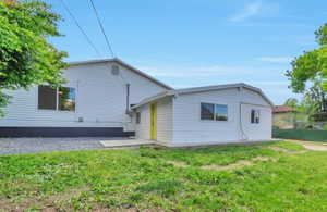 Rear view of house with a yard