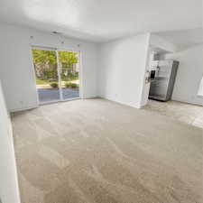 Unfurnished living room with light carpet.