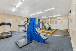 Exercise room with a textured ceiling