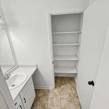 Bathroom with vanity and light tile patterned flooring