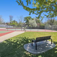 View of tennis court and a nice bench