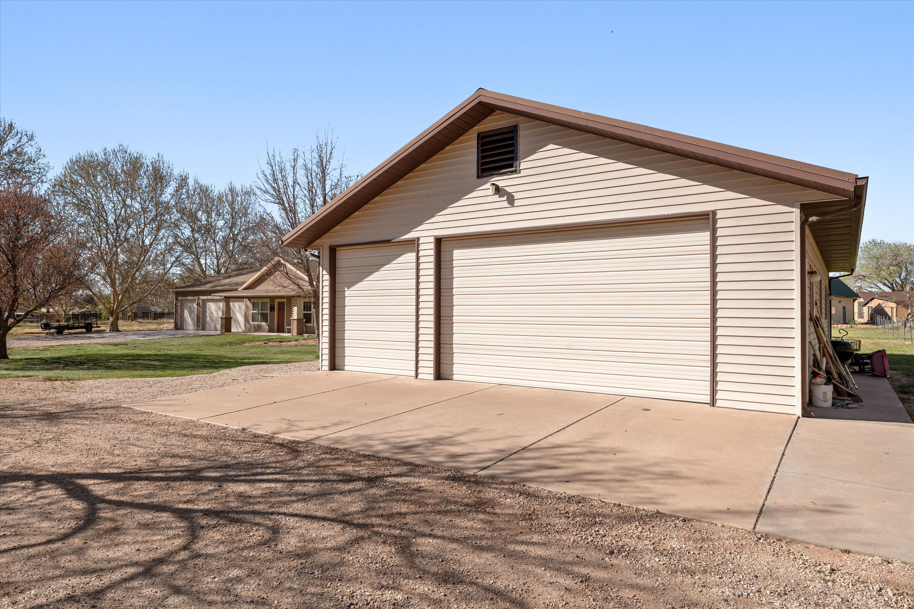 View of home's exterior featuring a garage and an outbuilding