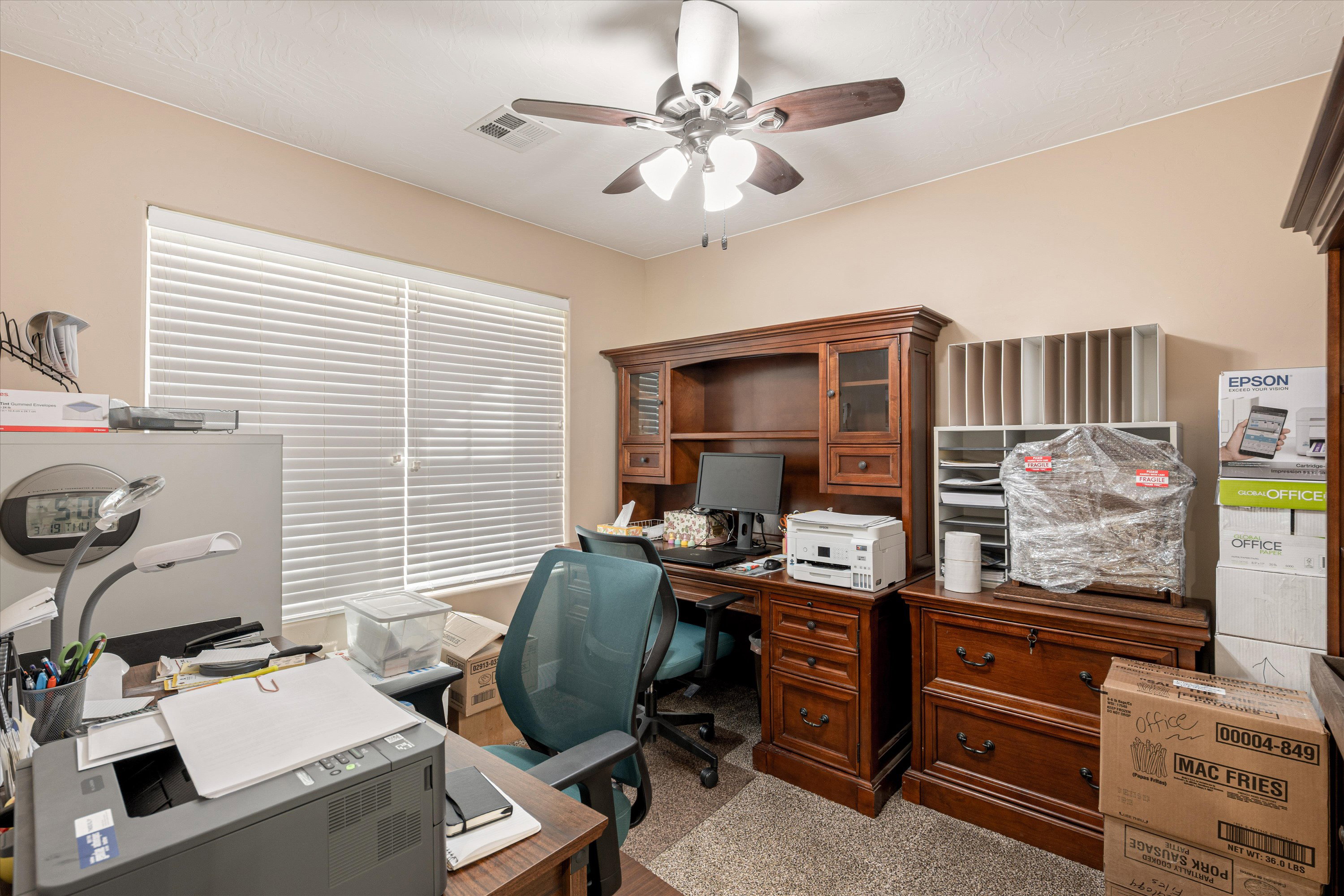 Home office featuring a ceiling fan and carpet flooring