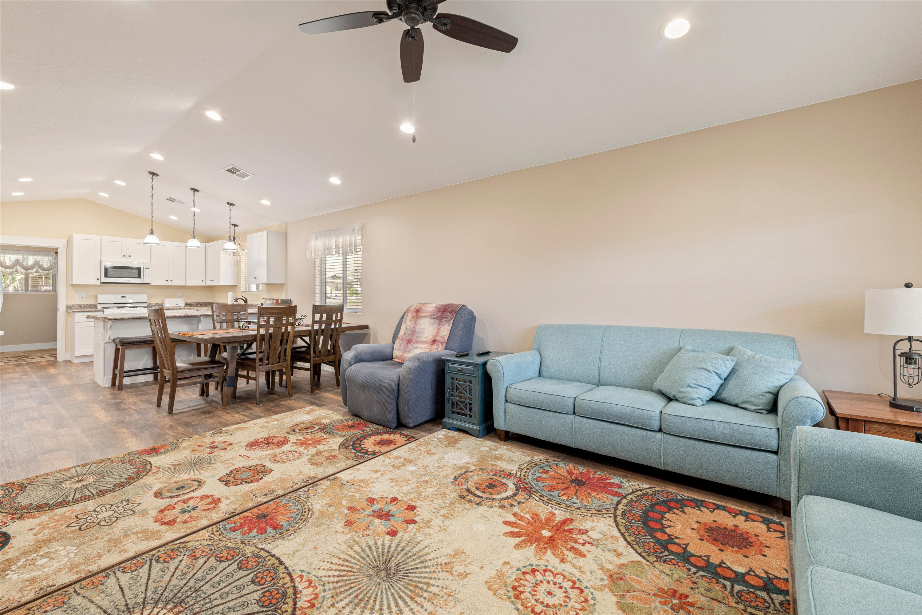 Living room featuring dark wood finished floors, recessed lighting, and ceiling fan
