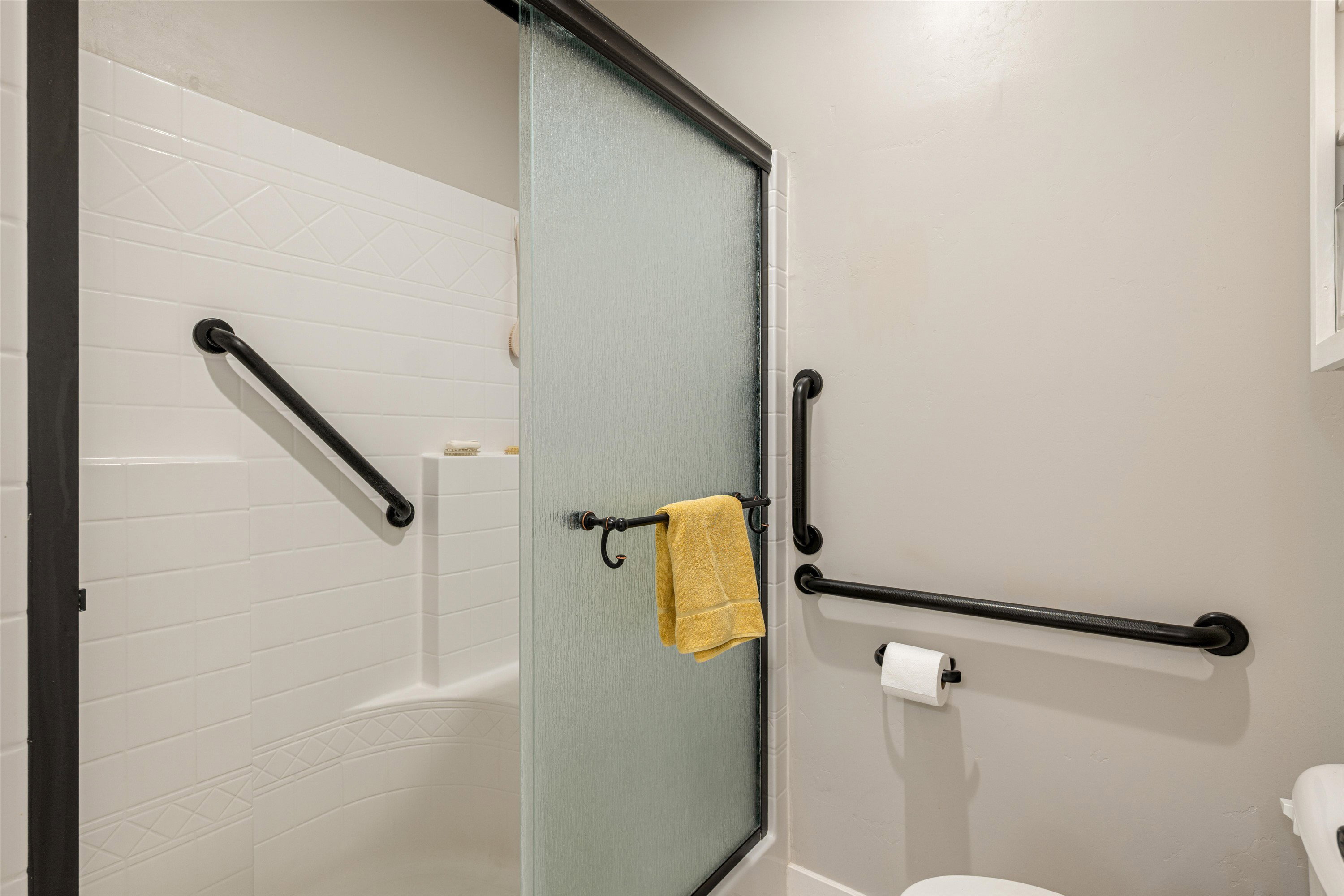 Bathroom featuring toilet and a stall shower