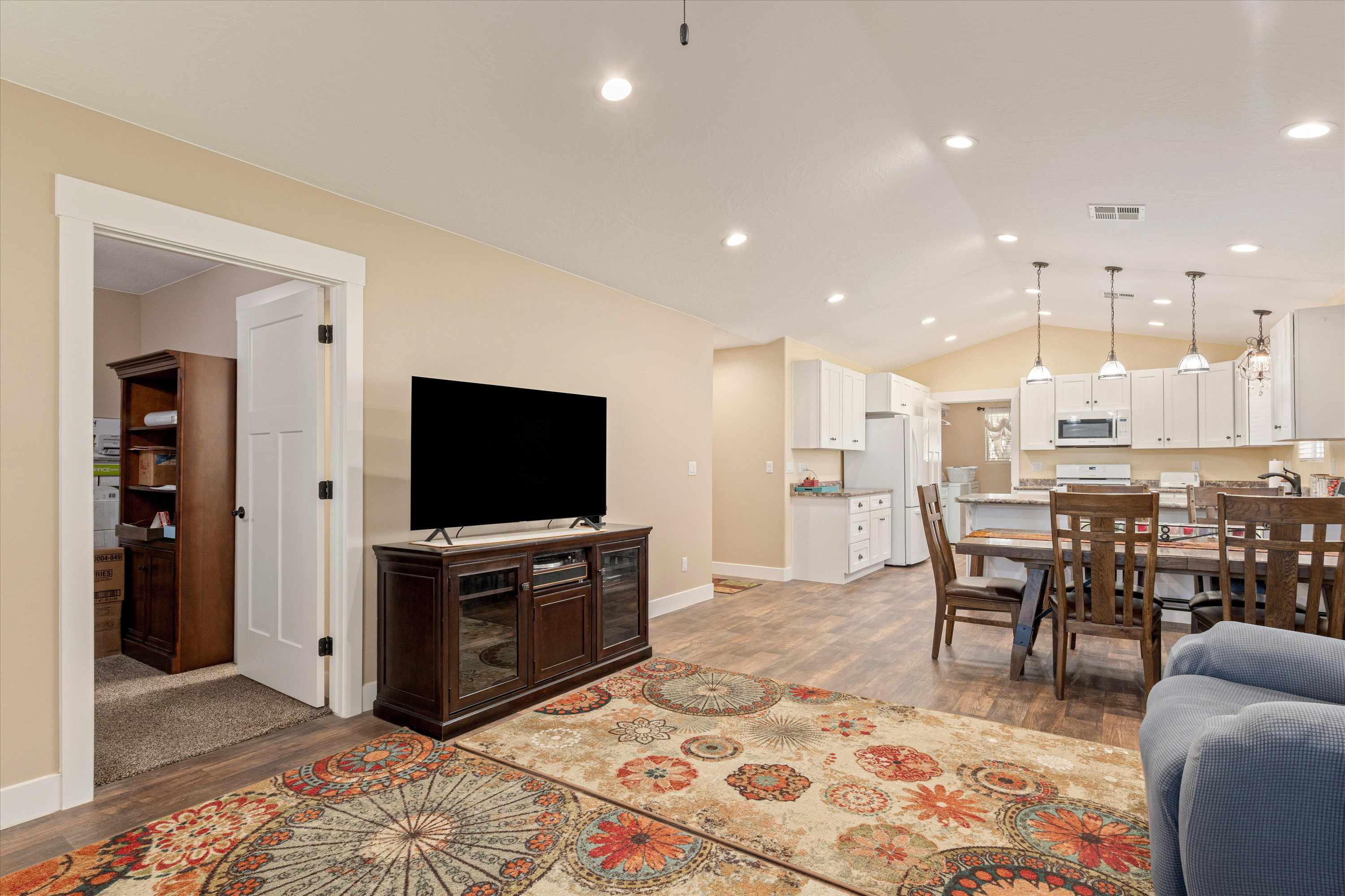 Living area featuring dark wood-style floors and recessed lighting