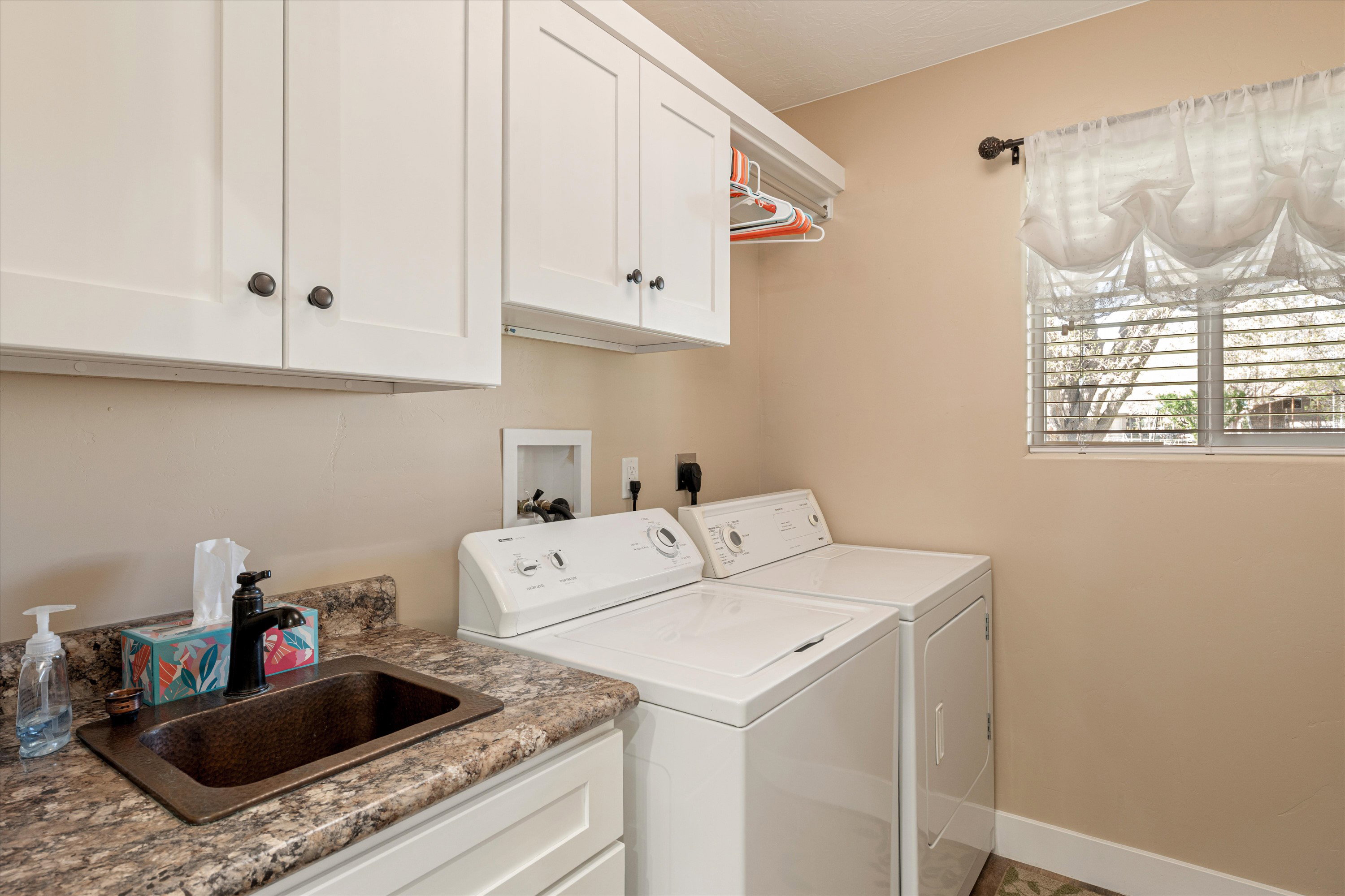 Laundry area with washer and clothes dryer and cabinet space