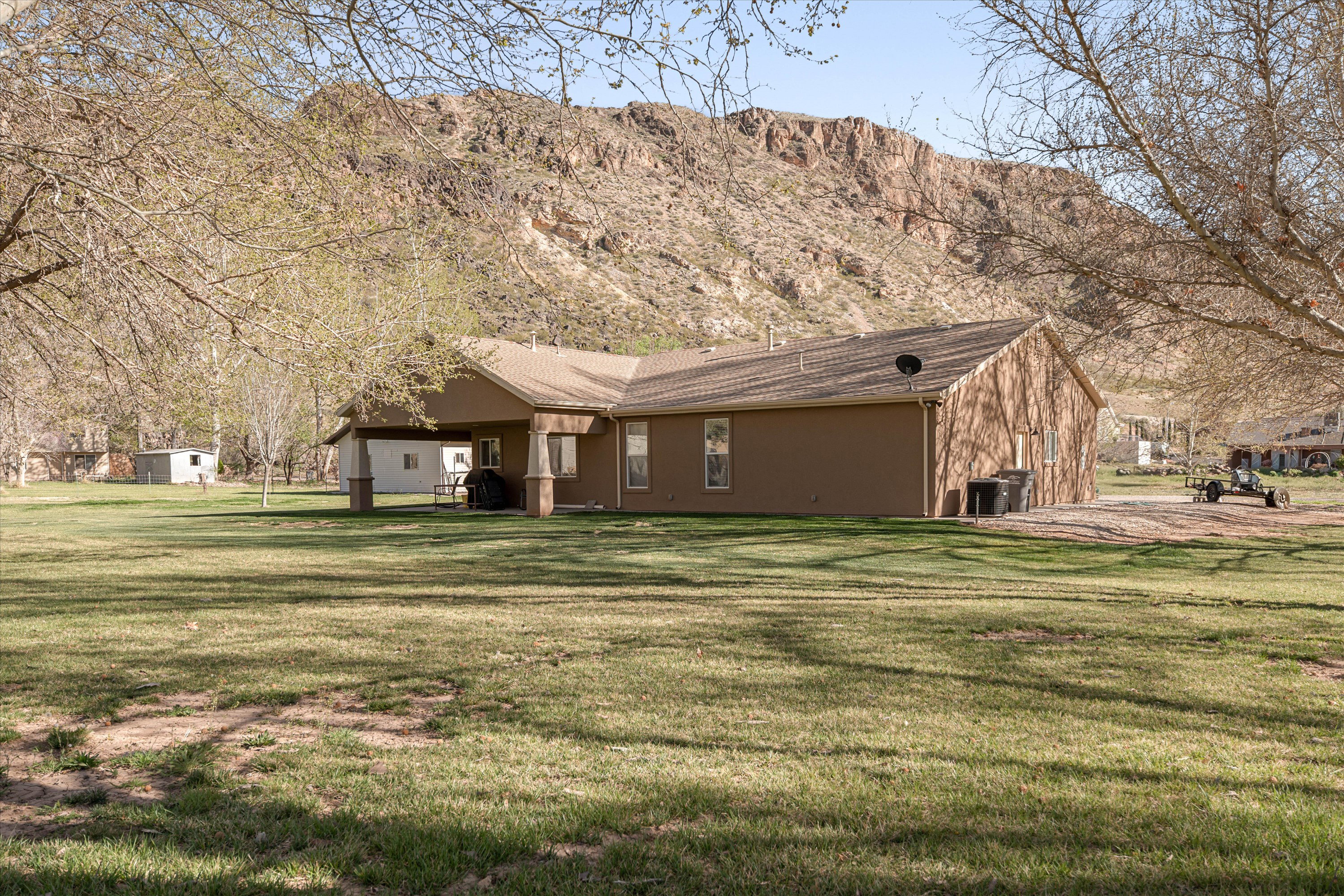 View of home's exterior with a yard and a mountain view