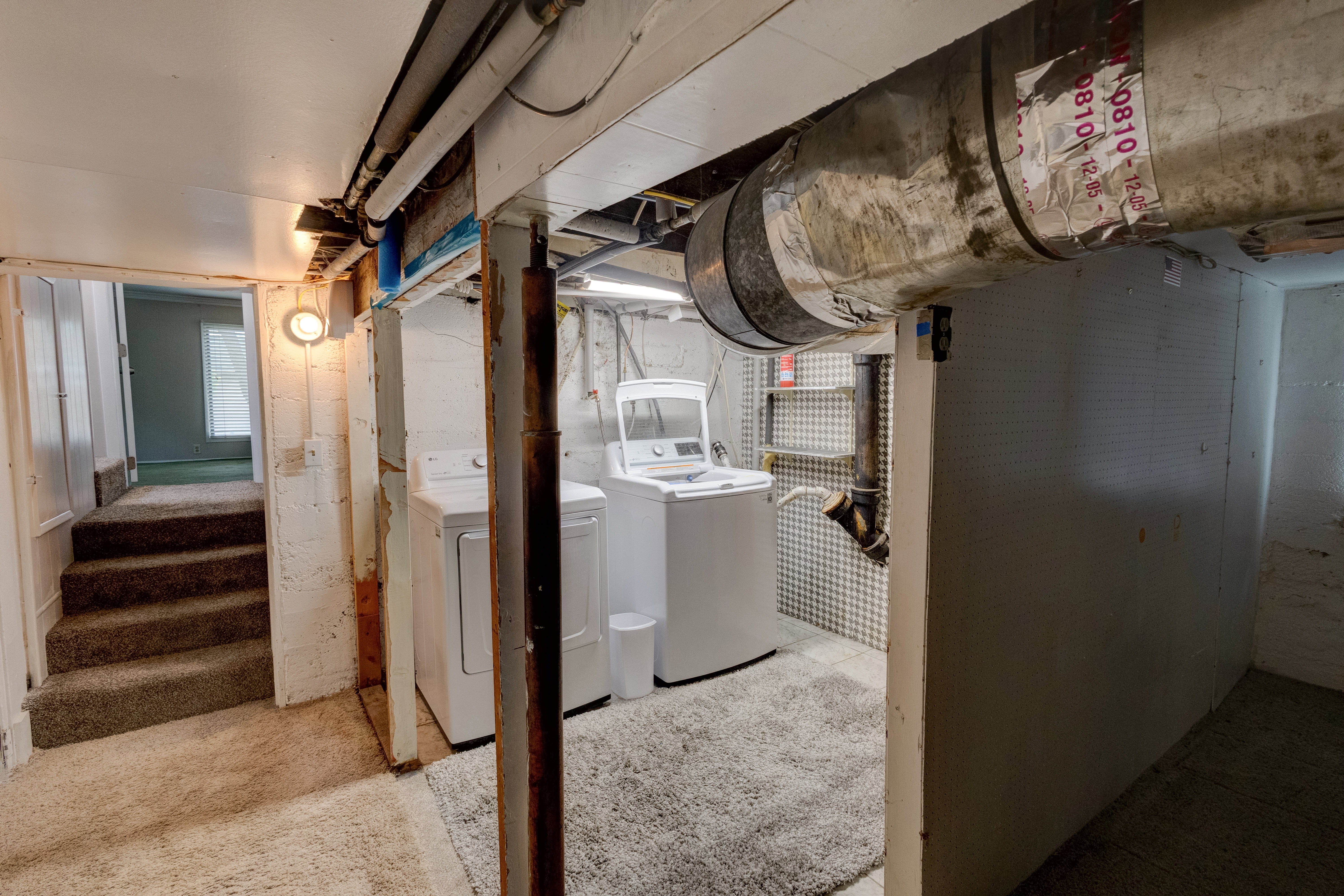 Unfinished basement, laundry area.