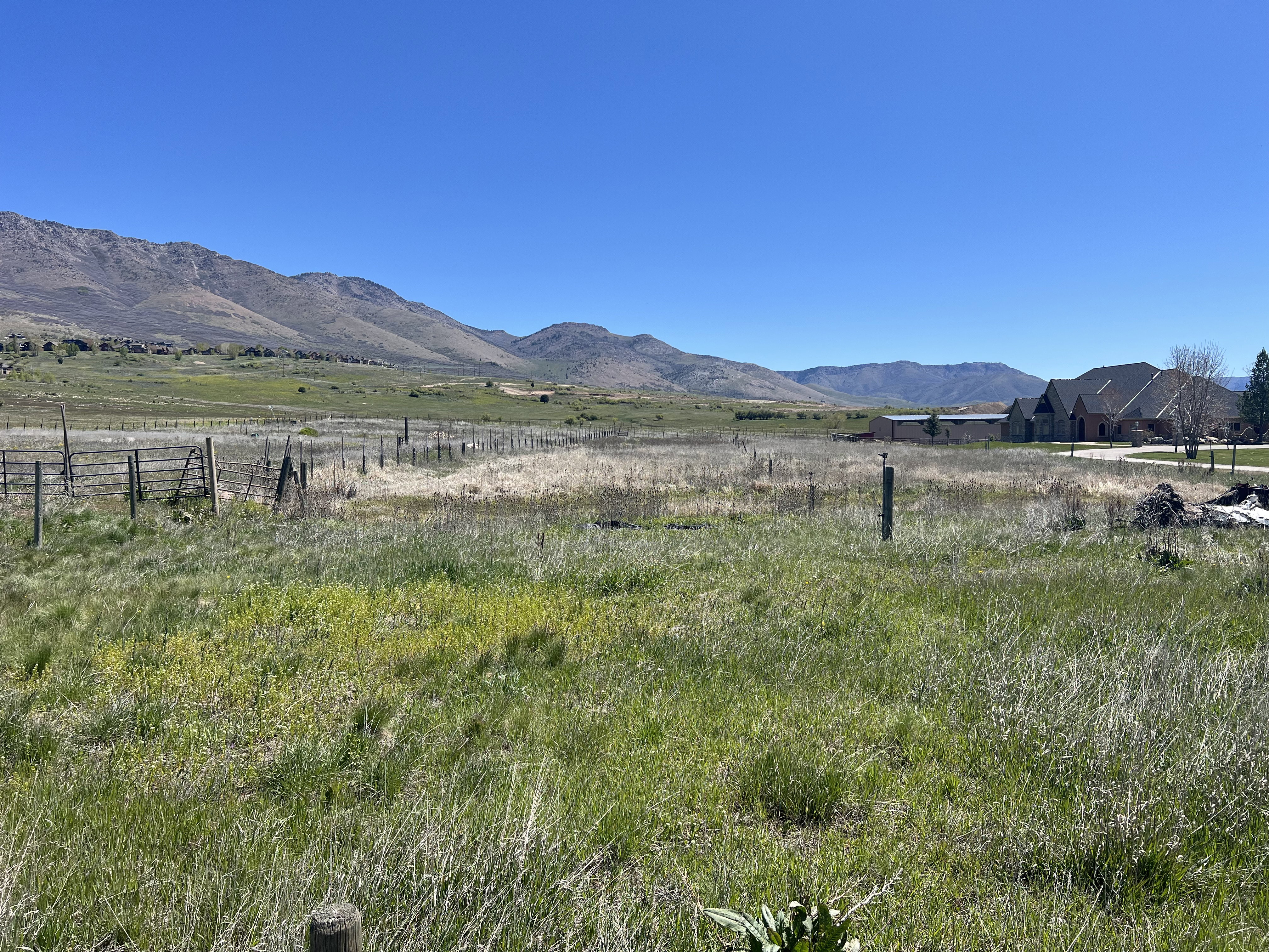 View of mountain backdrop with rural landscape