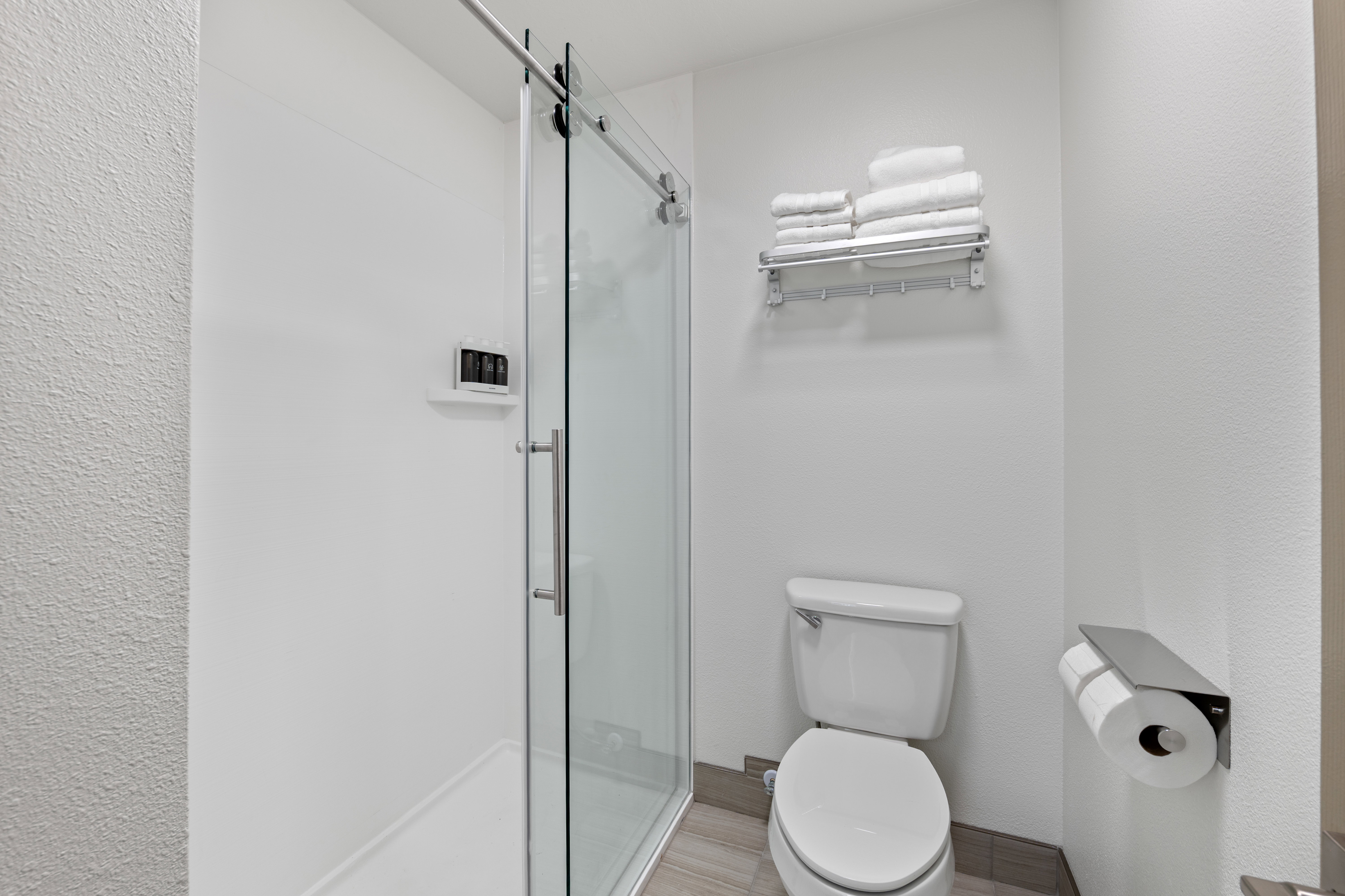 Bathroom featuring a stall shower and toilet