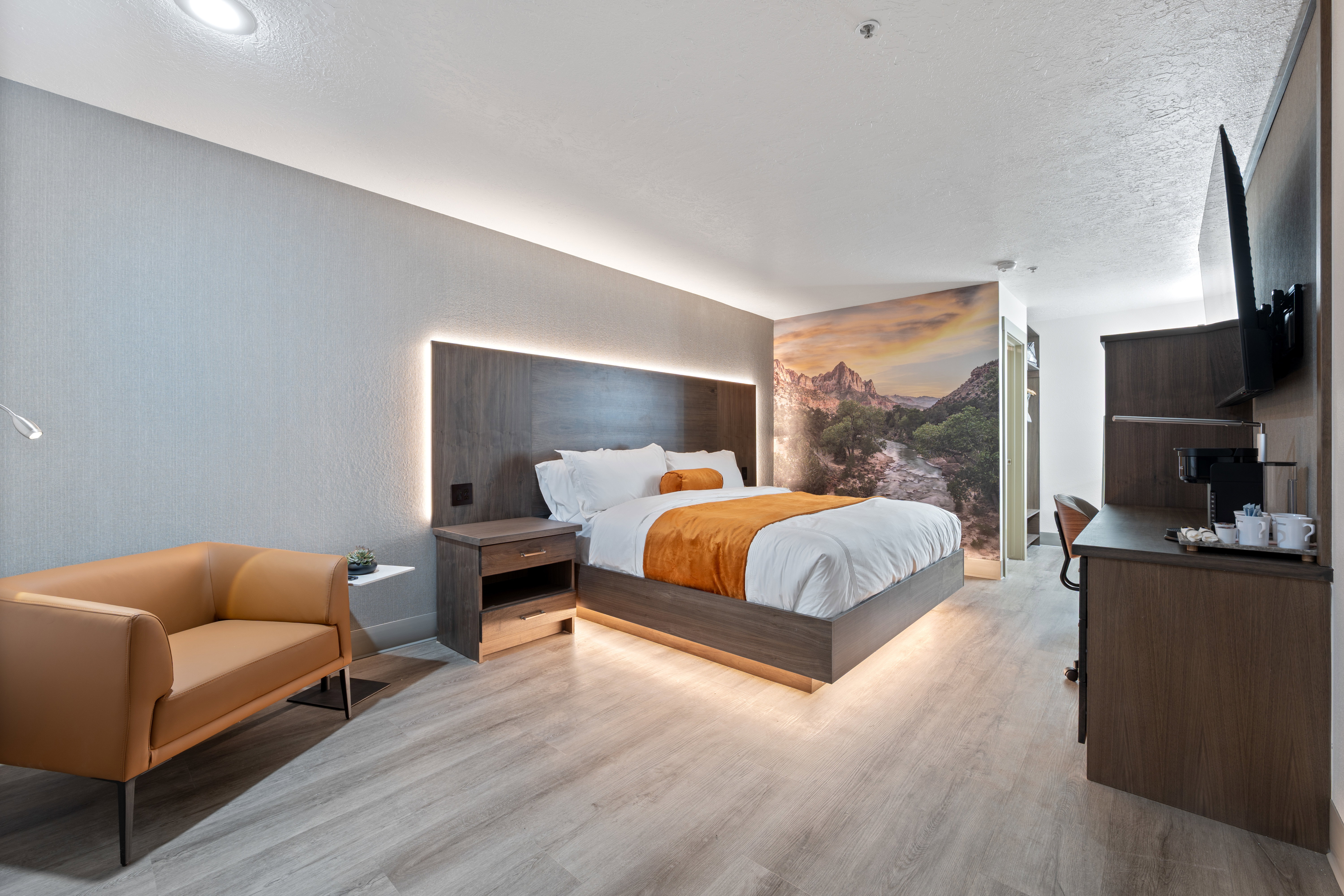 Bedroom featuring light wood-type flooring and a textured wall