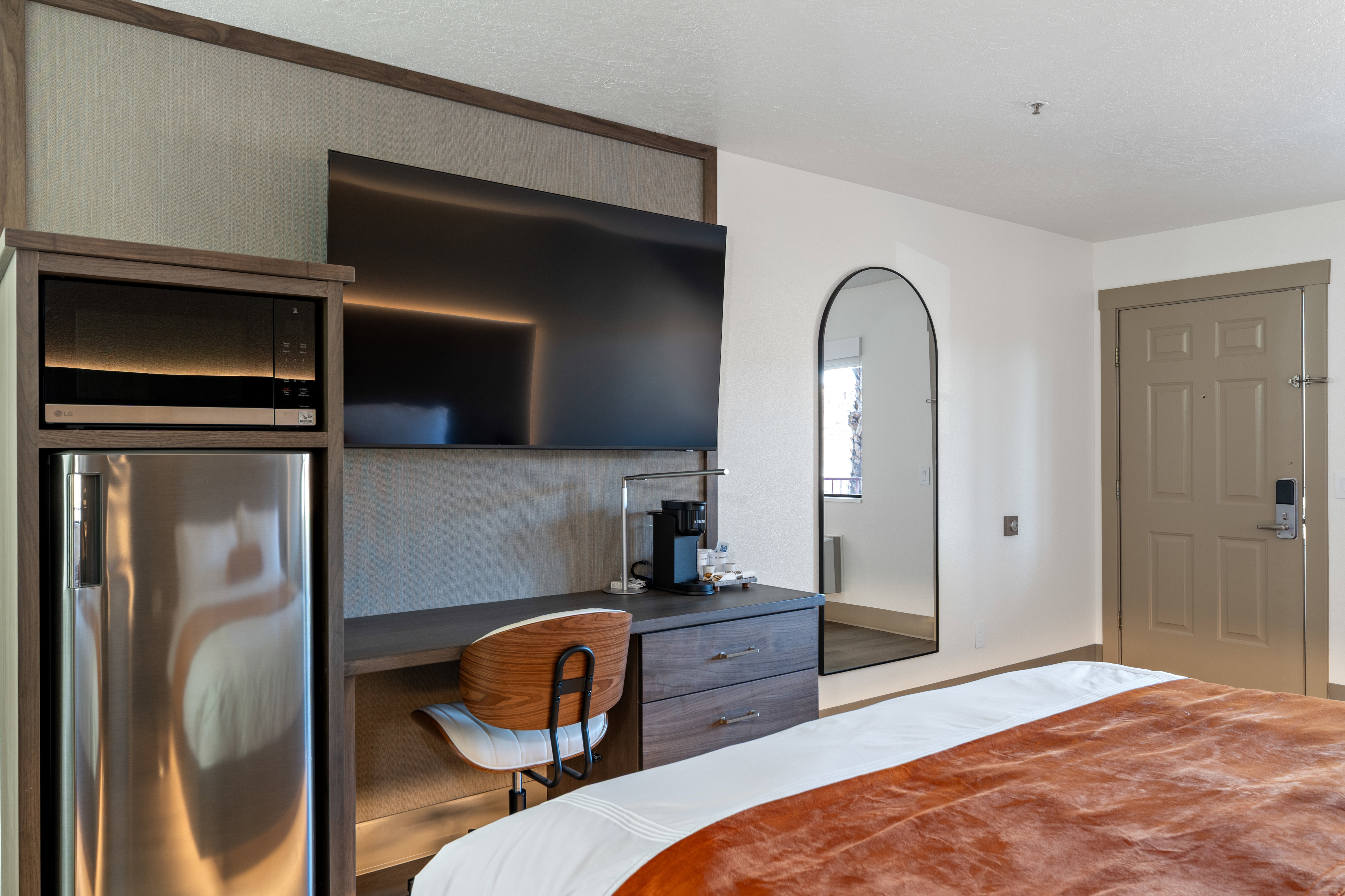 Bedroom featuring stainless steel refrigerator