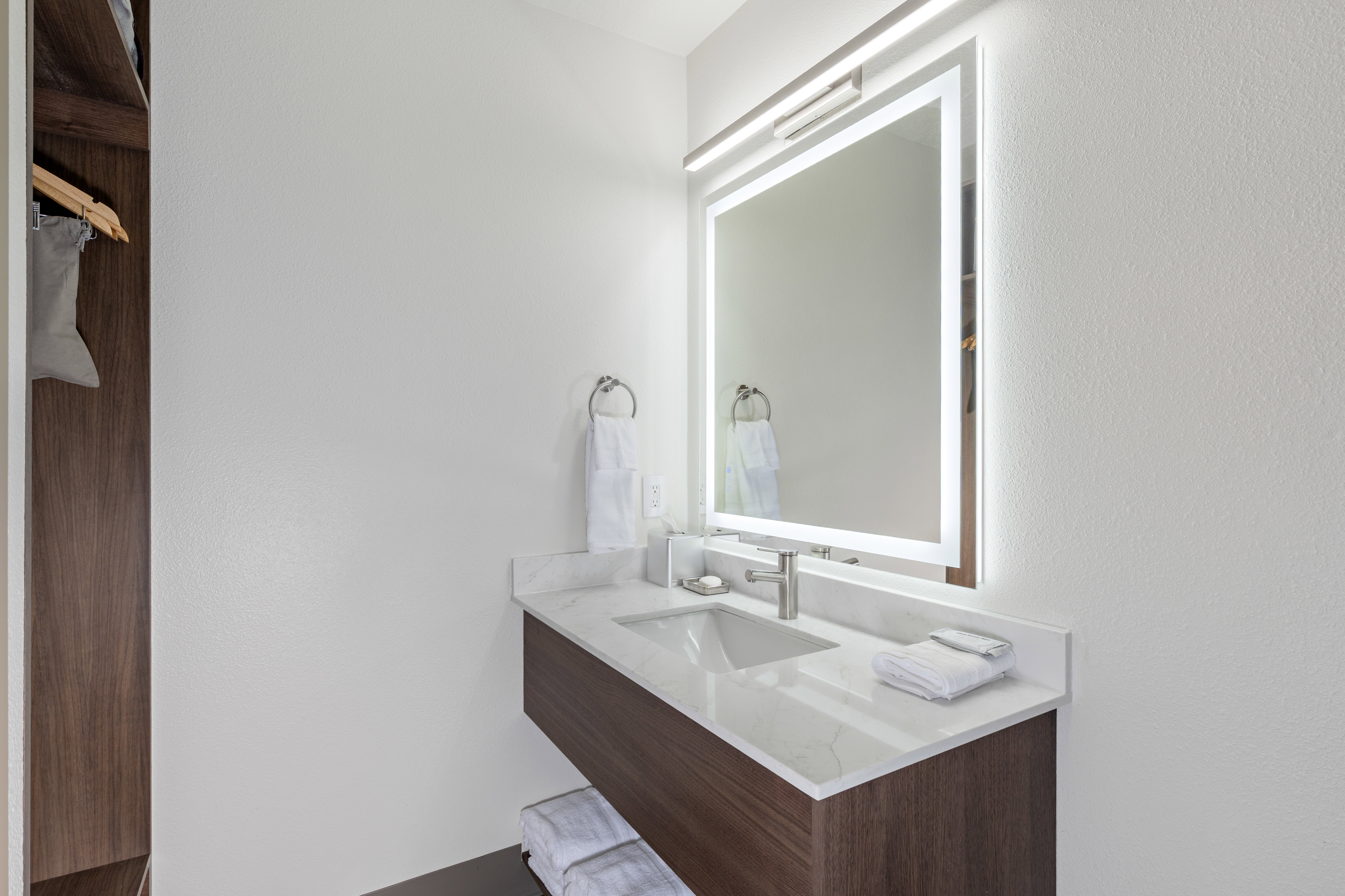 Bathroom with vanity and a textured wall