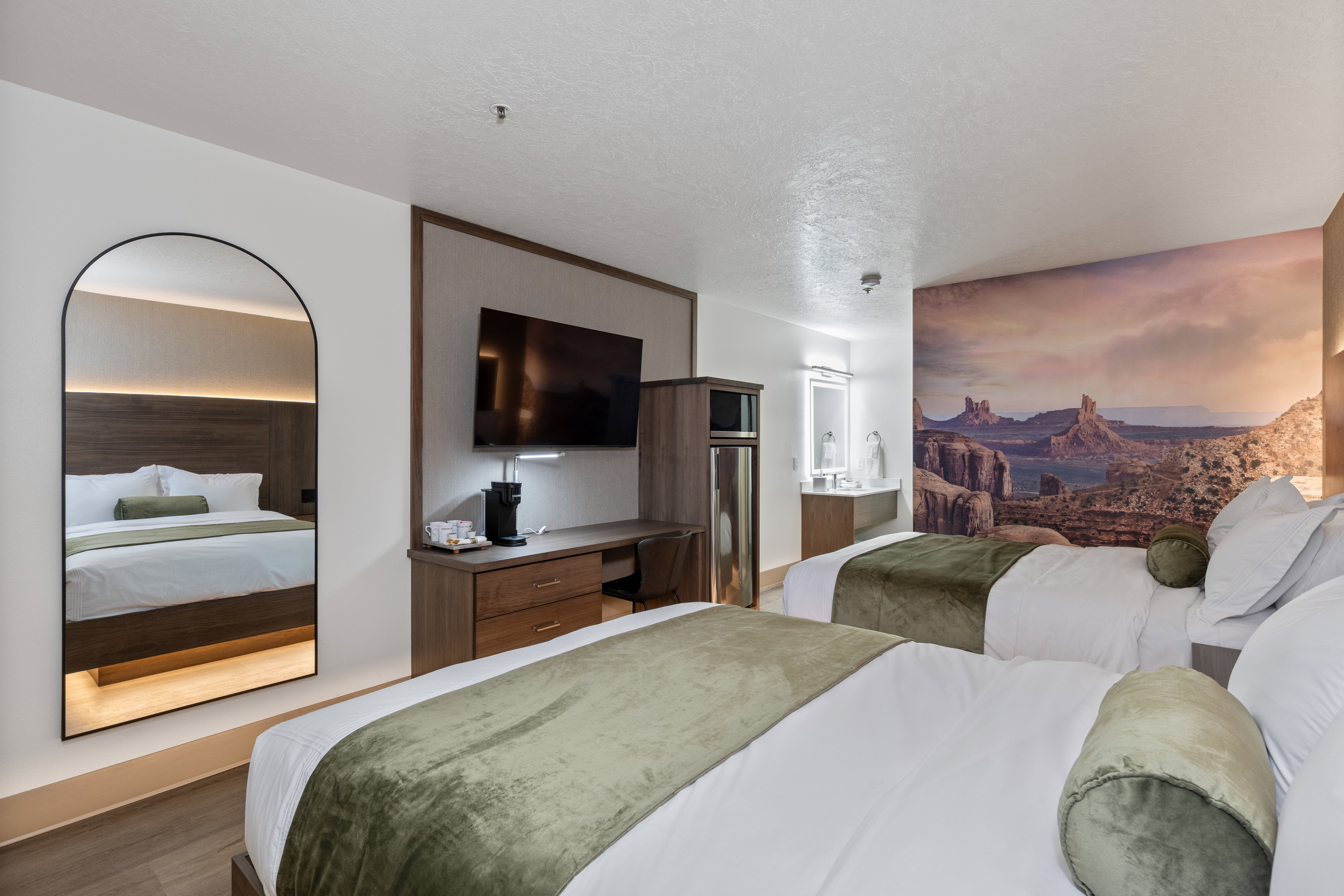 Bedroom with a textured ceiling, wood finished floors, and ensuite bathroom