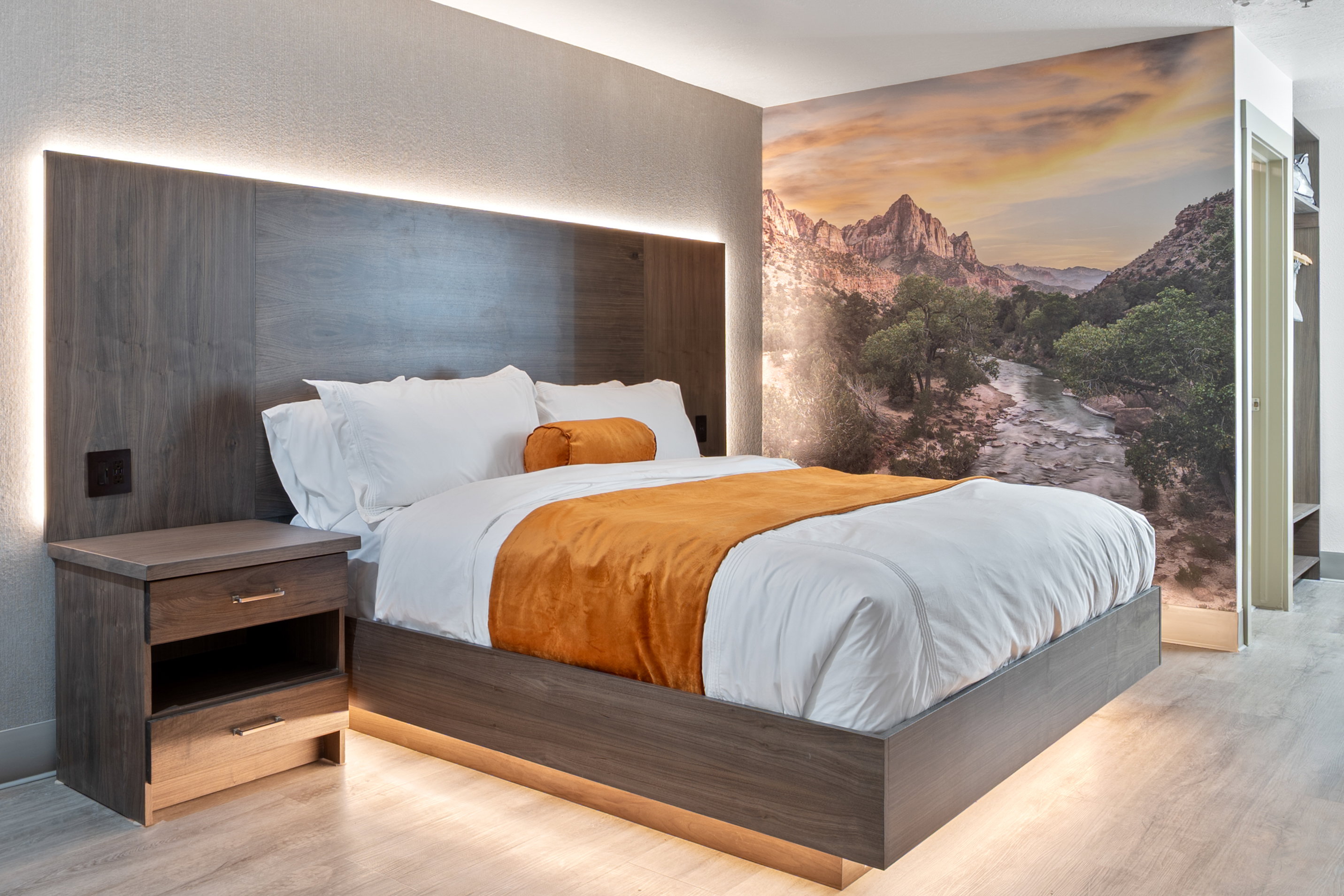 Bedroom with wood finished floors and a textured wall