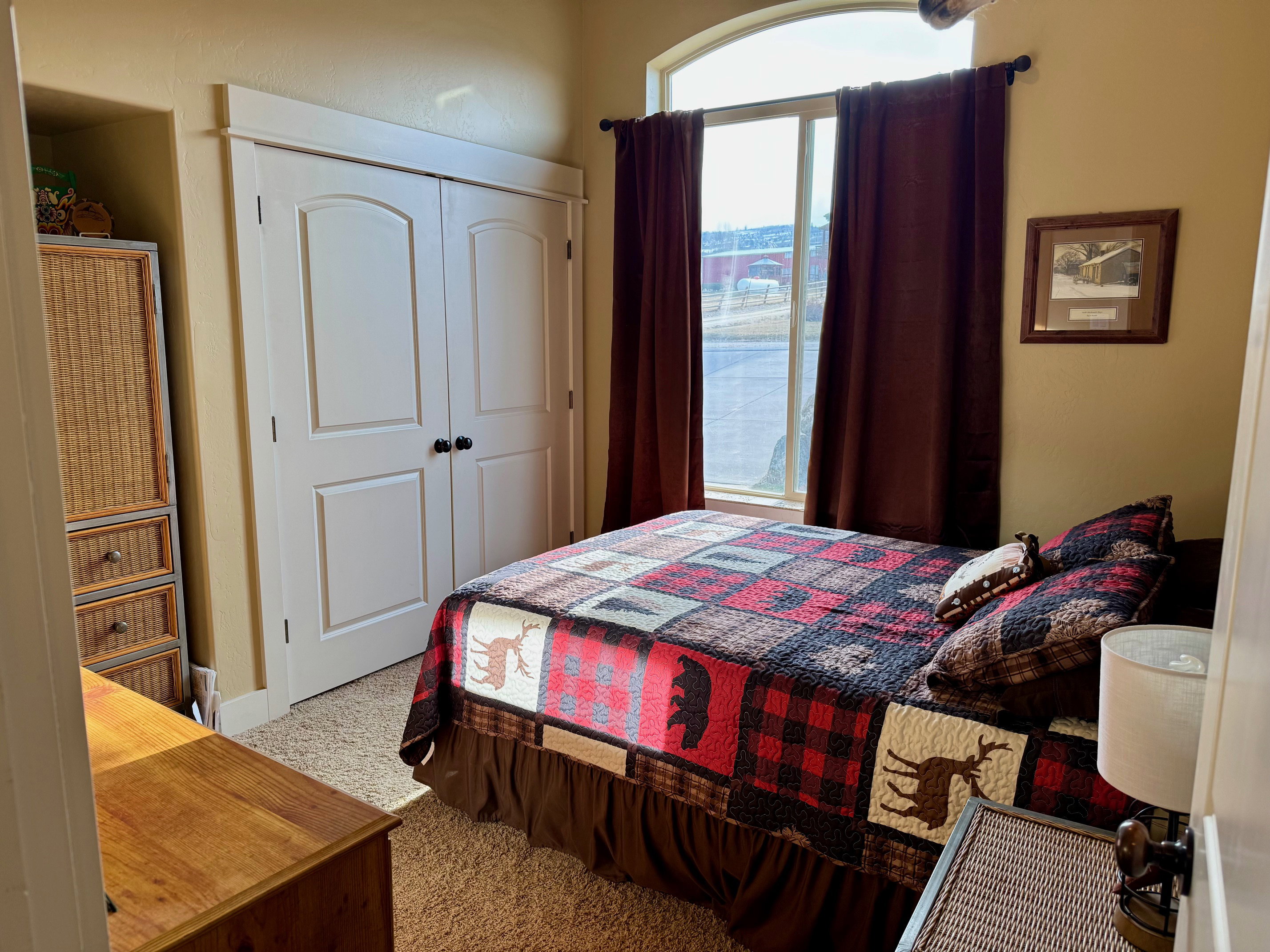 Bedroom with light carpet and a closet
