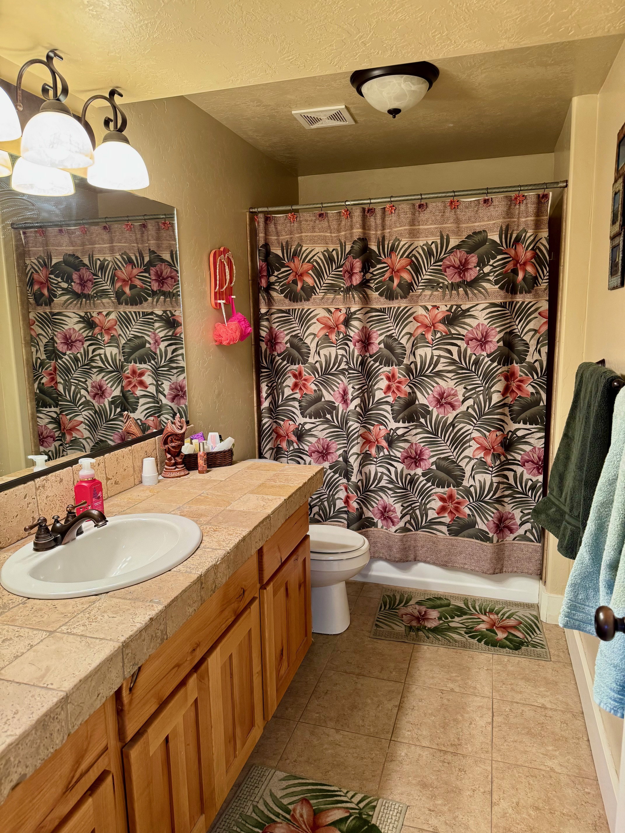 Full bath with vanity, shower / tub combo, a light tile patterned floors