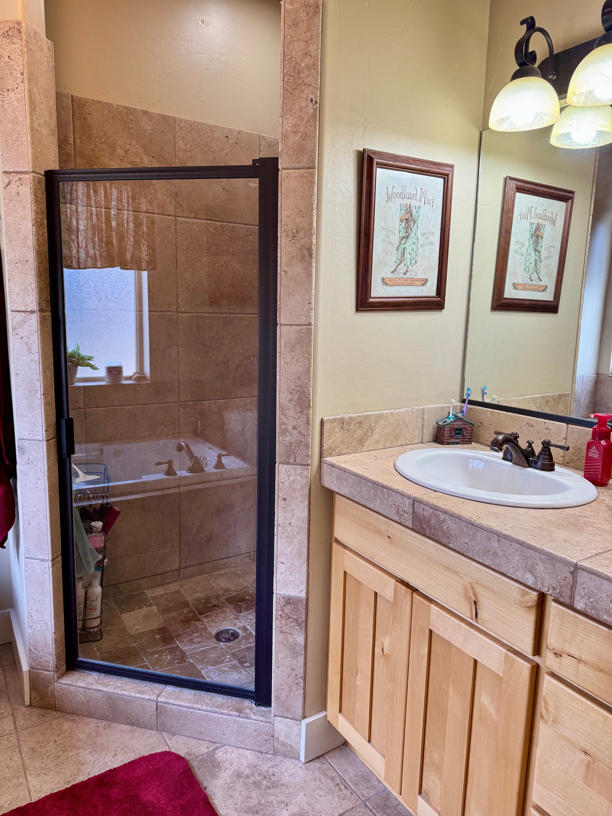 Full bath with a separate shower, vanity, and light tile patterned floors