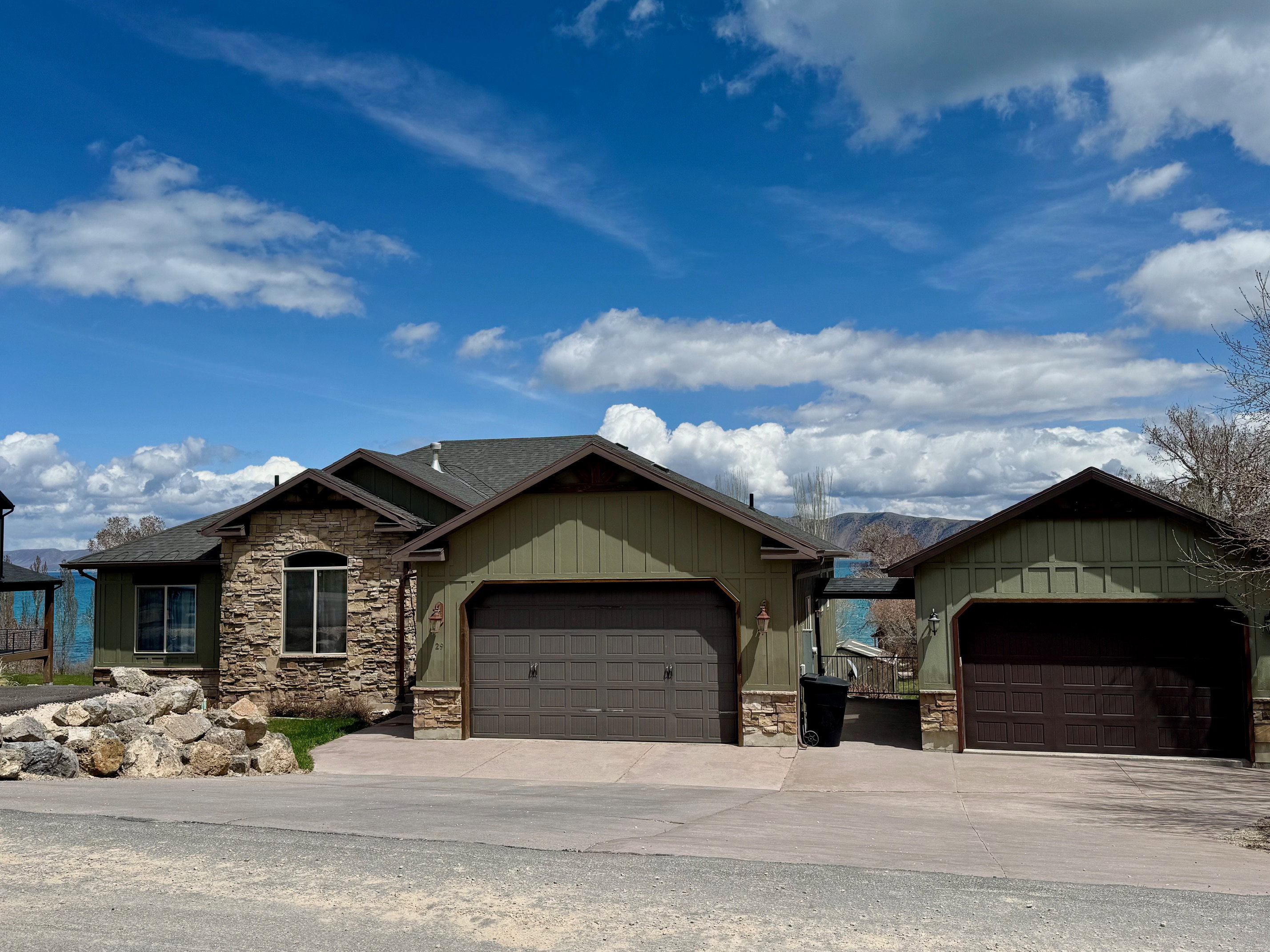 Craftsman house with stone/cement-board siding, a 2-car attached plus detached garage