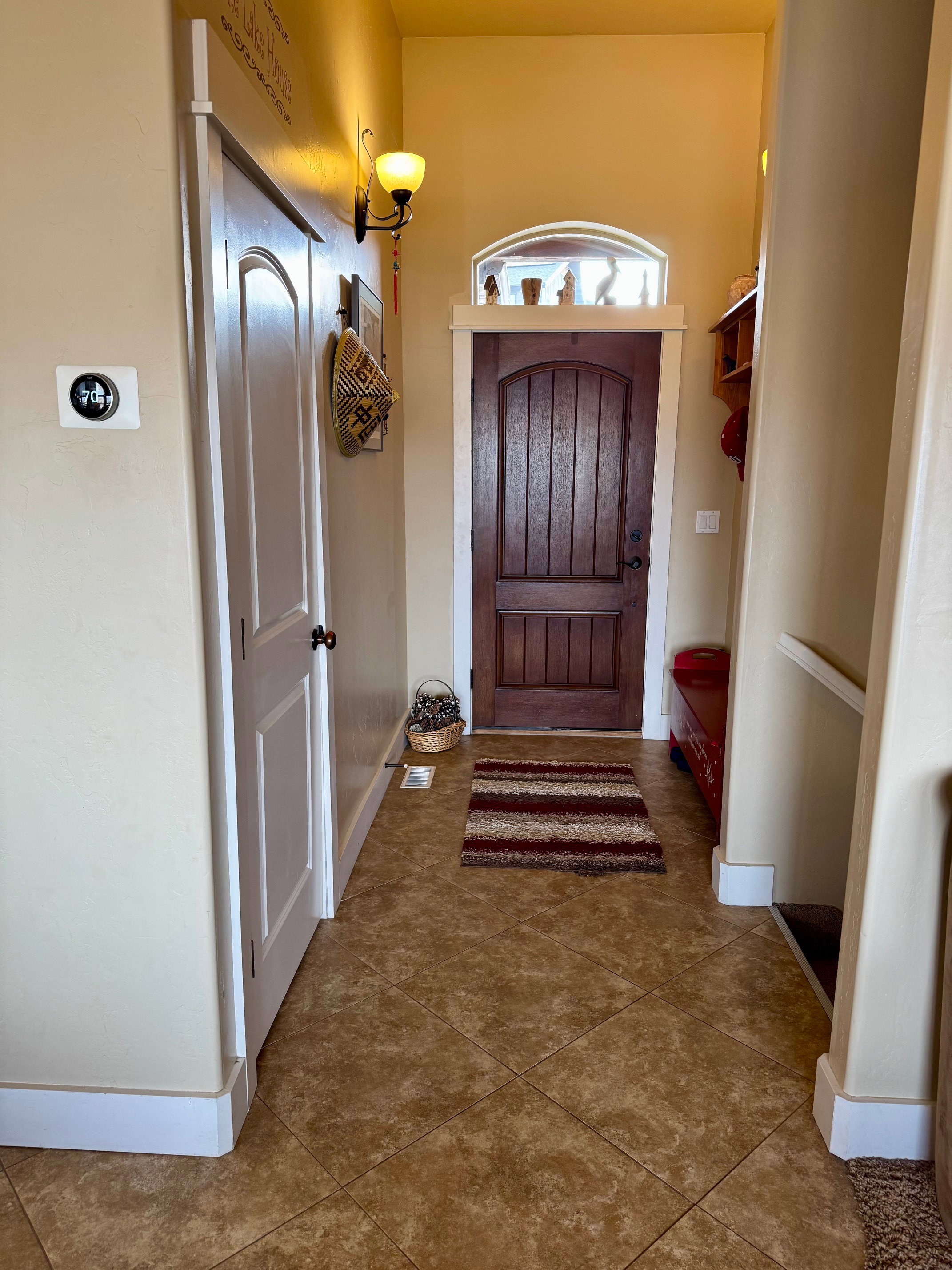 Foyer with dark tile patterned flooring