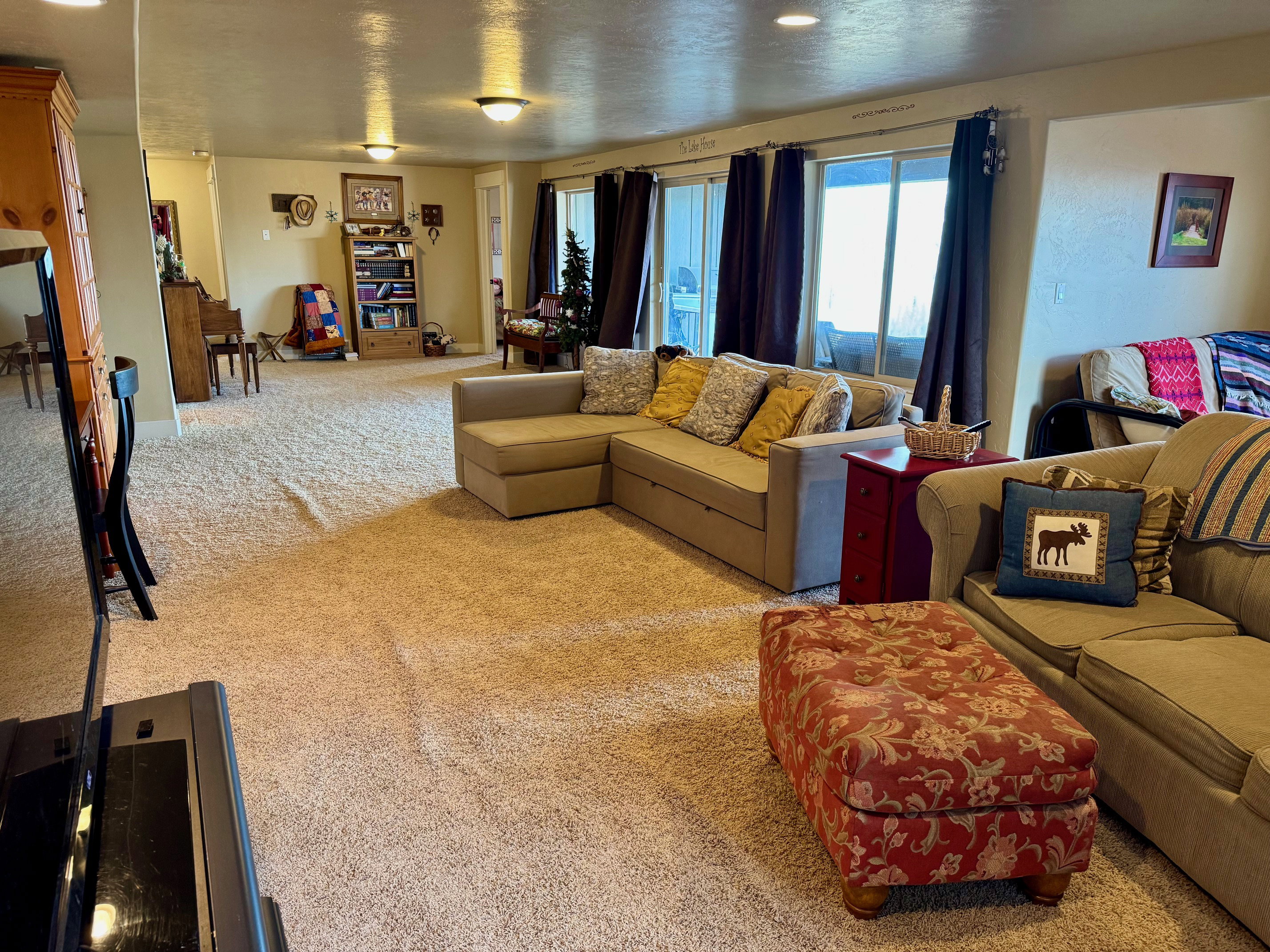 Lower level Living room with large windows to patio and lake view