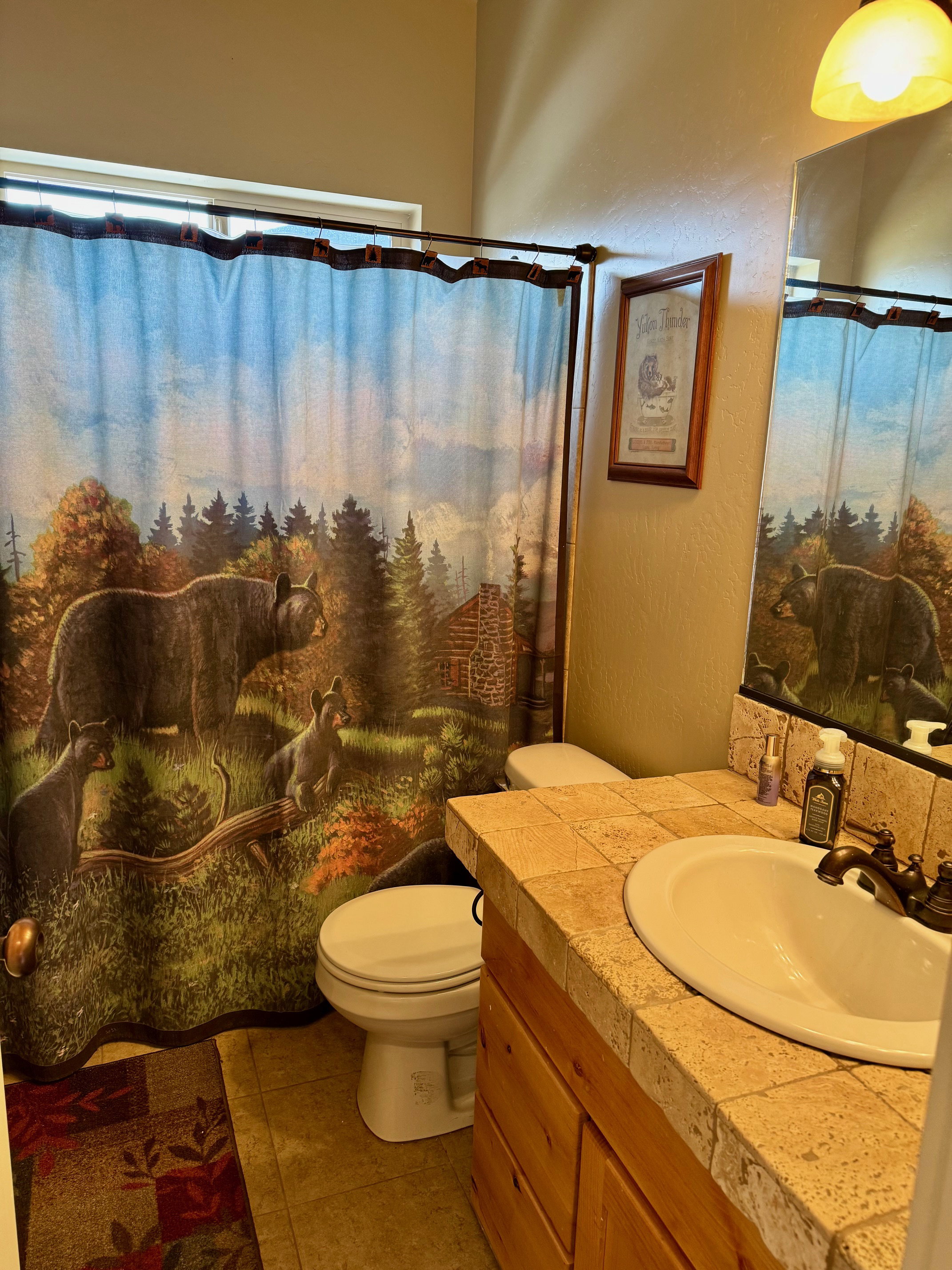 Bathroom featuring a shower with shower curtain, vanity, and light tile patterned flooring
