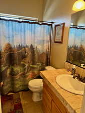 Bathroom featuring a shower with shower curtain, vanity, and light tile patterned flooring