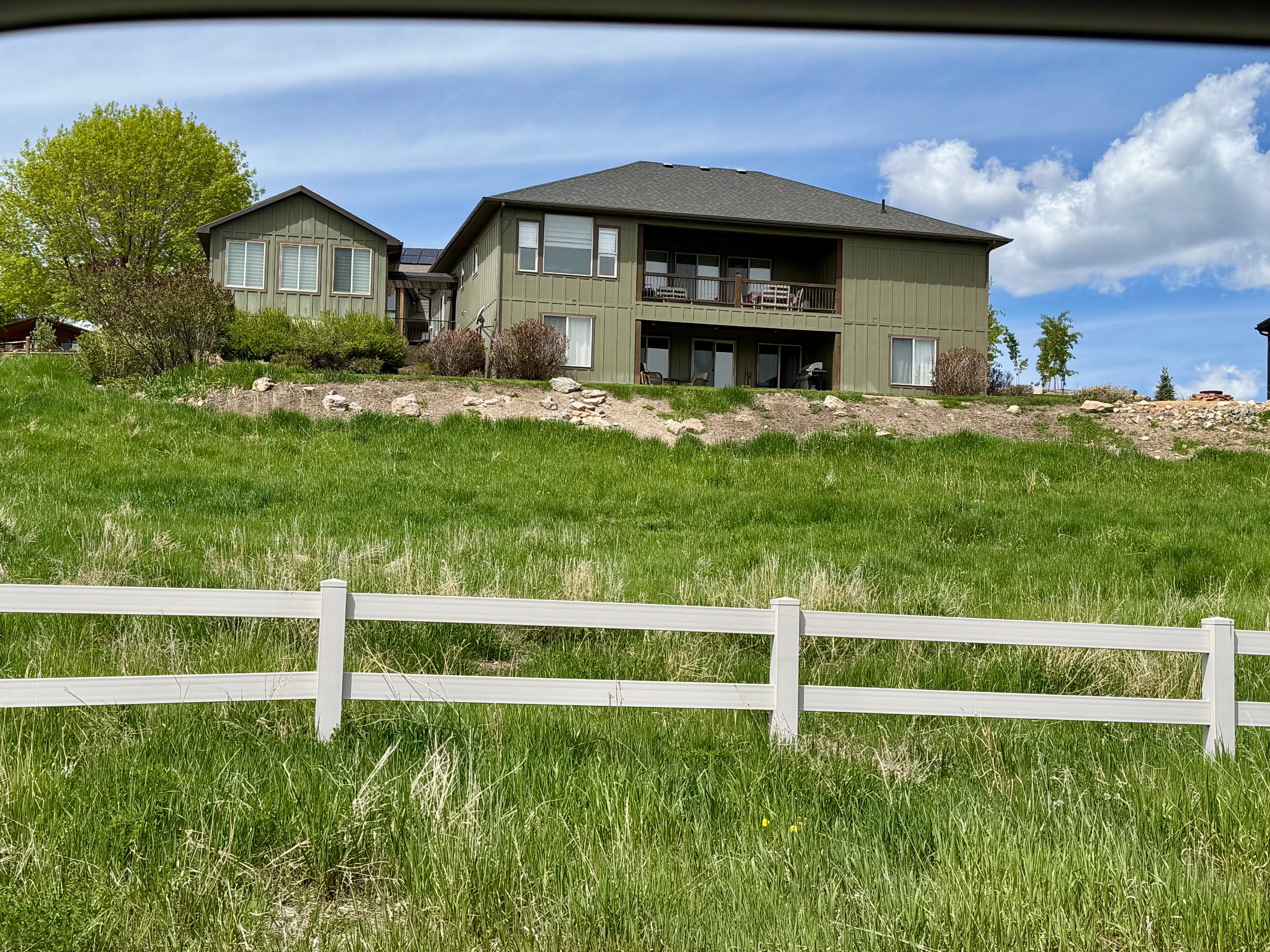 Rear view of house featuring .56-acre lot