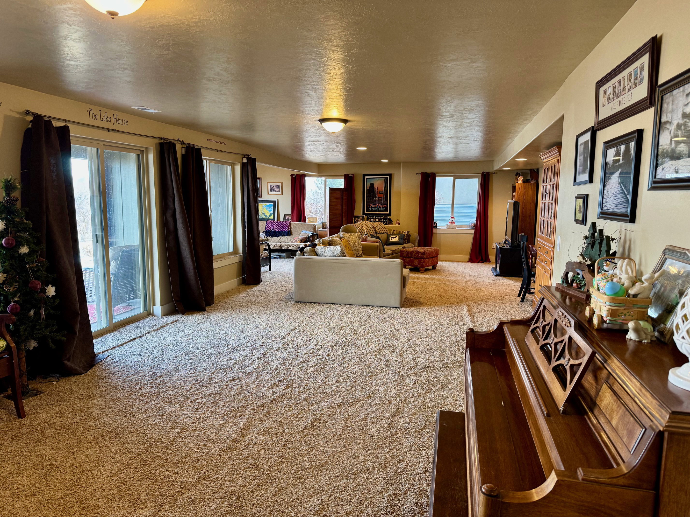 Lower level living room with lsliding glass door to patio with lake view