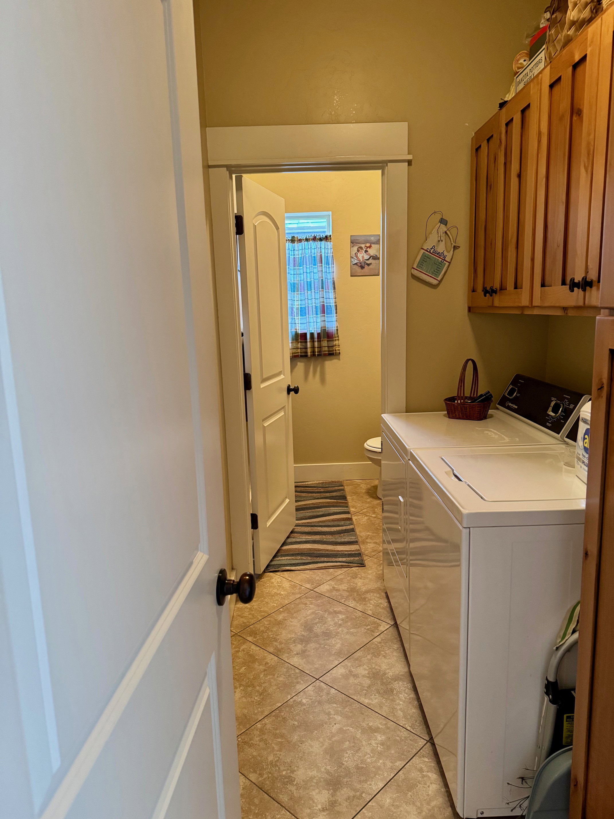 Laundry area featuring washer and dryer and 1/2 bath