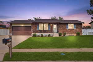 Ranch-style house with brick siding, concrete driveway, and a garage