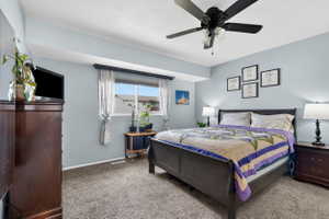 Bedroom with light colored carpet and ceiling fan