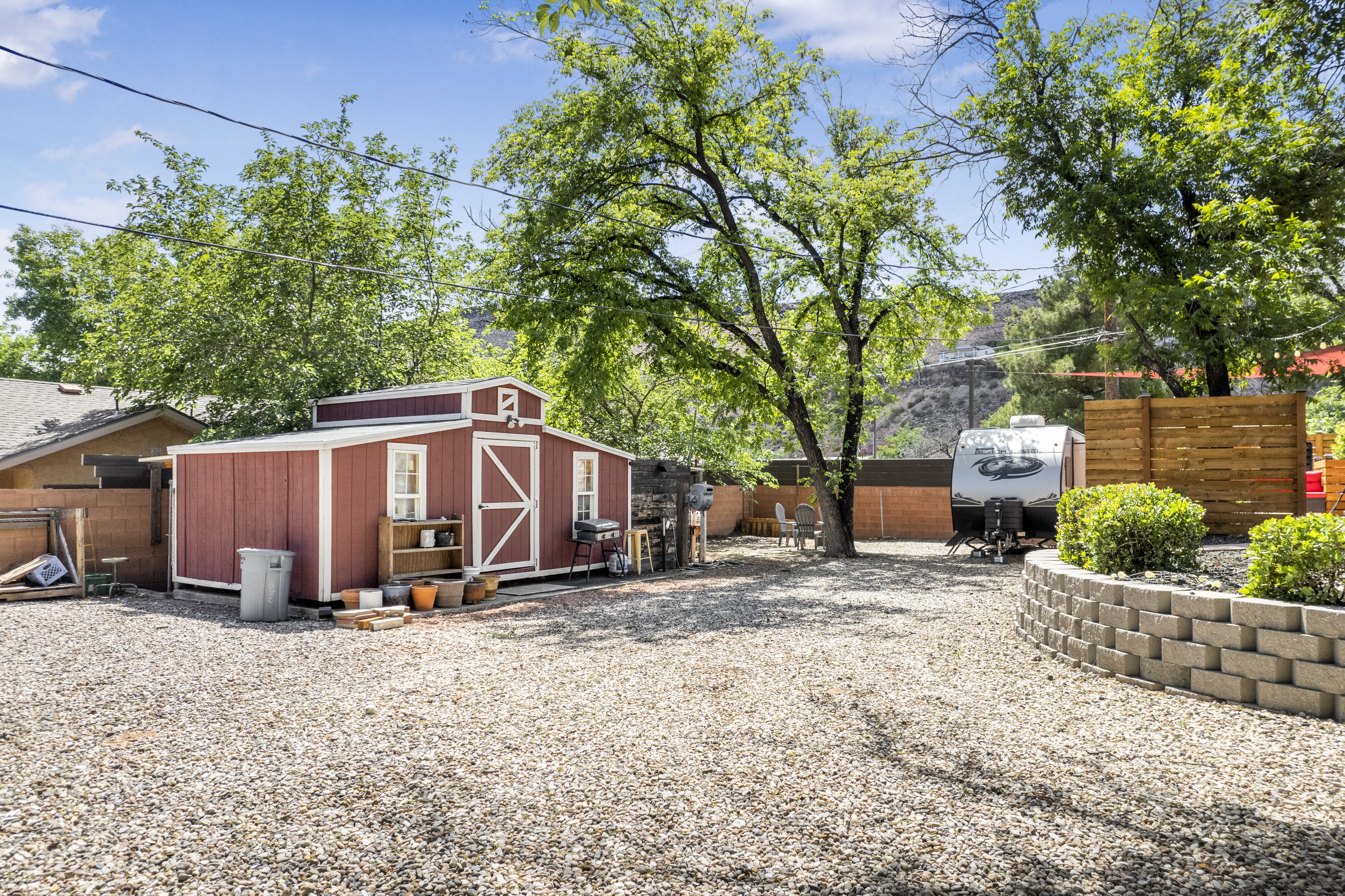 Fenced backyard with a storage shed