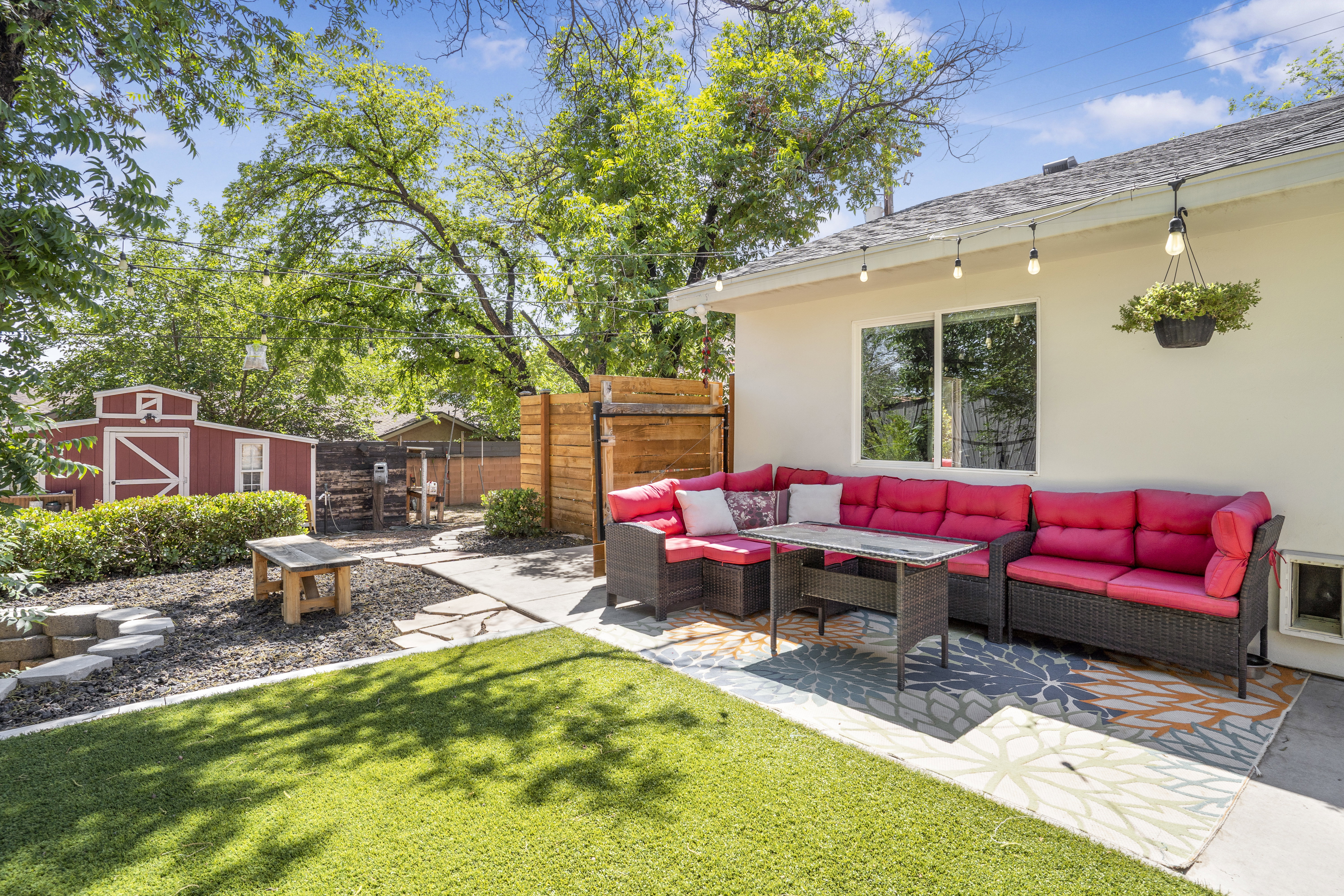 View of patio with outdoor seating and a shed