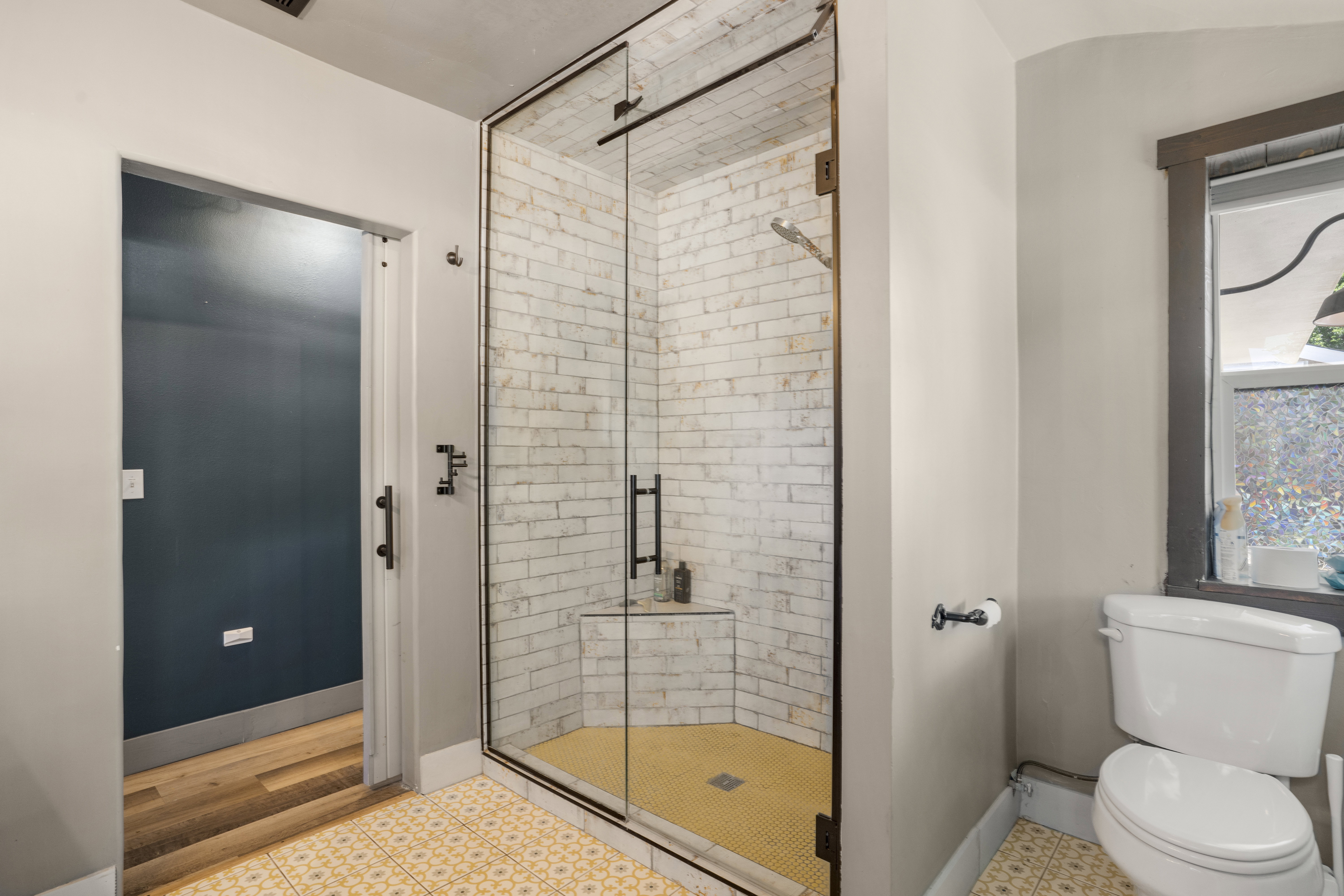 Bathroom featuring a shower stall and toilet