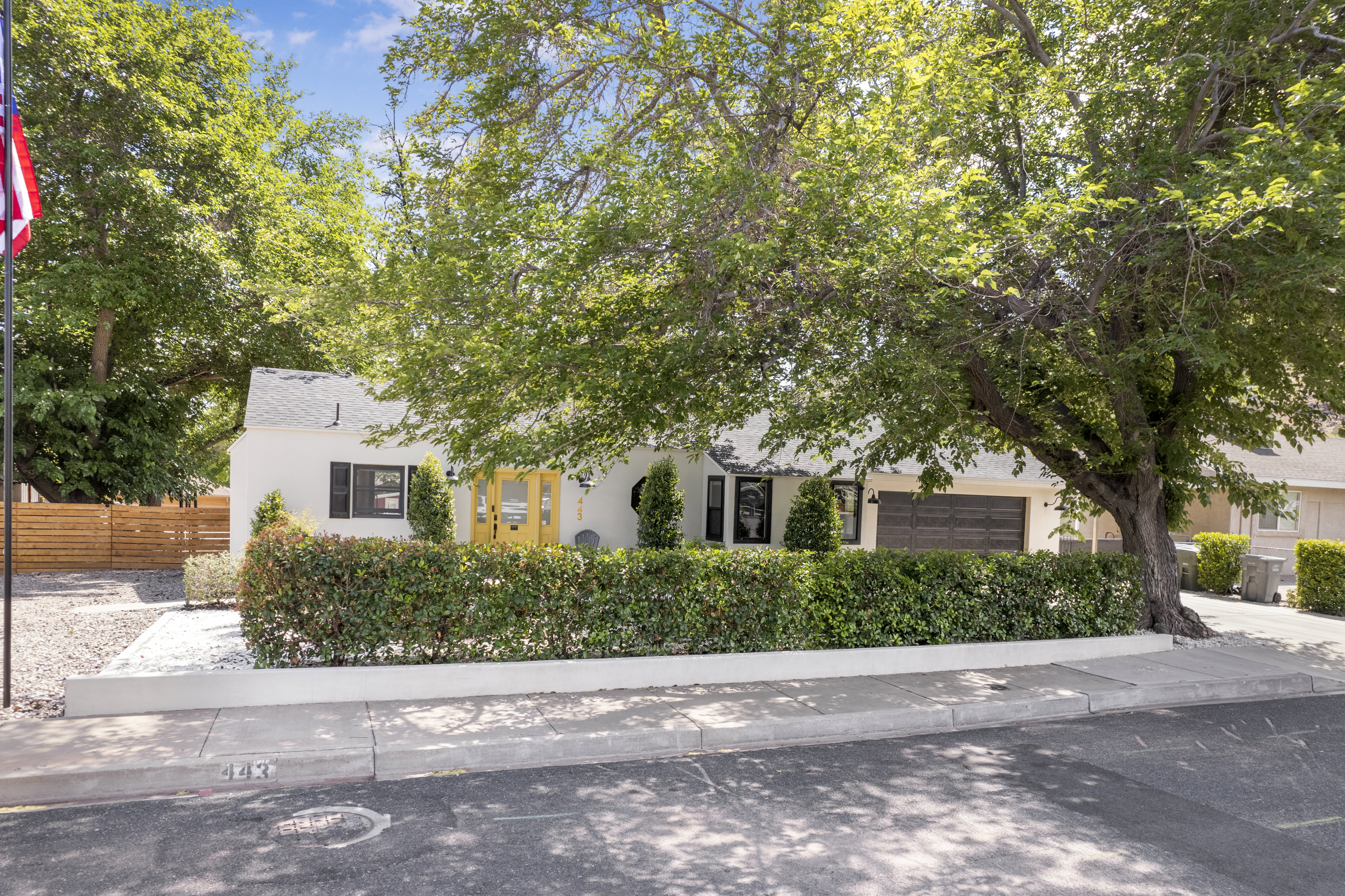 Obstructed view of property with stucco siding and a garage