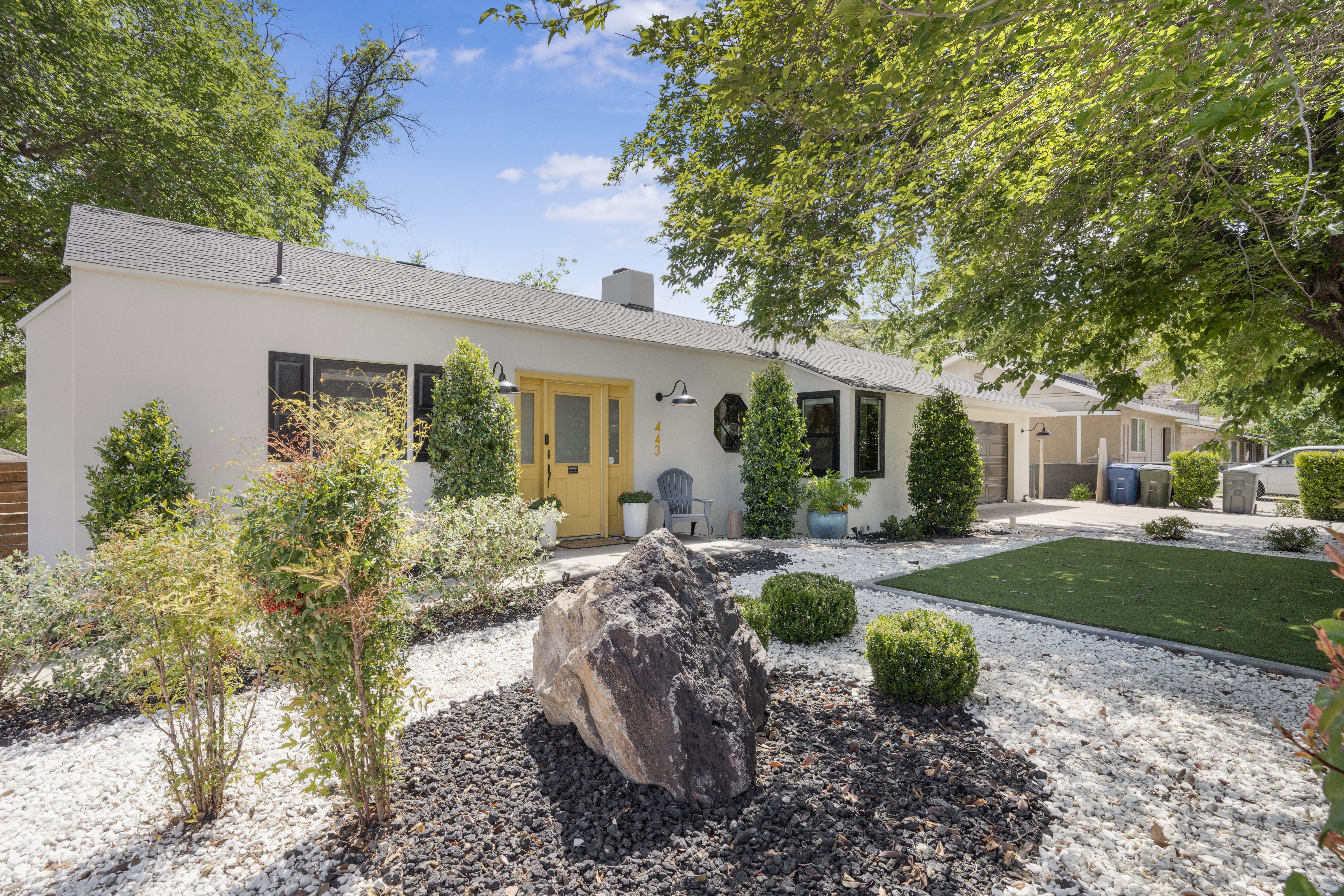 Single story home with an attached garage, a chimney, stucco siding, concrete driveway, and roof with shingles